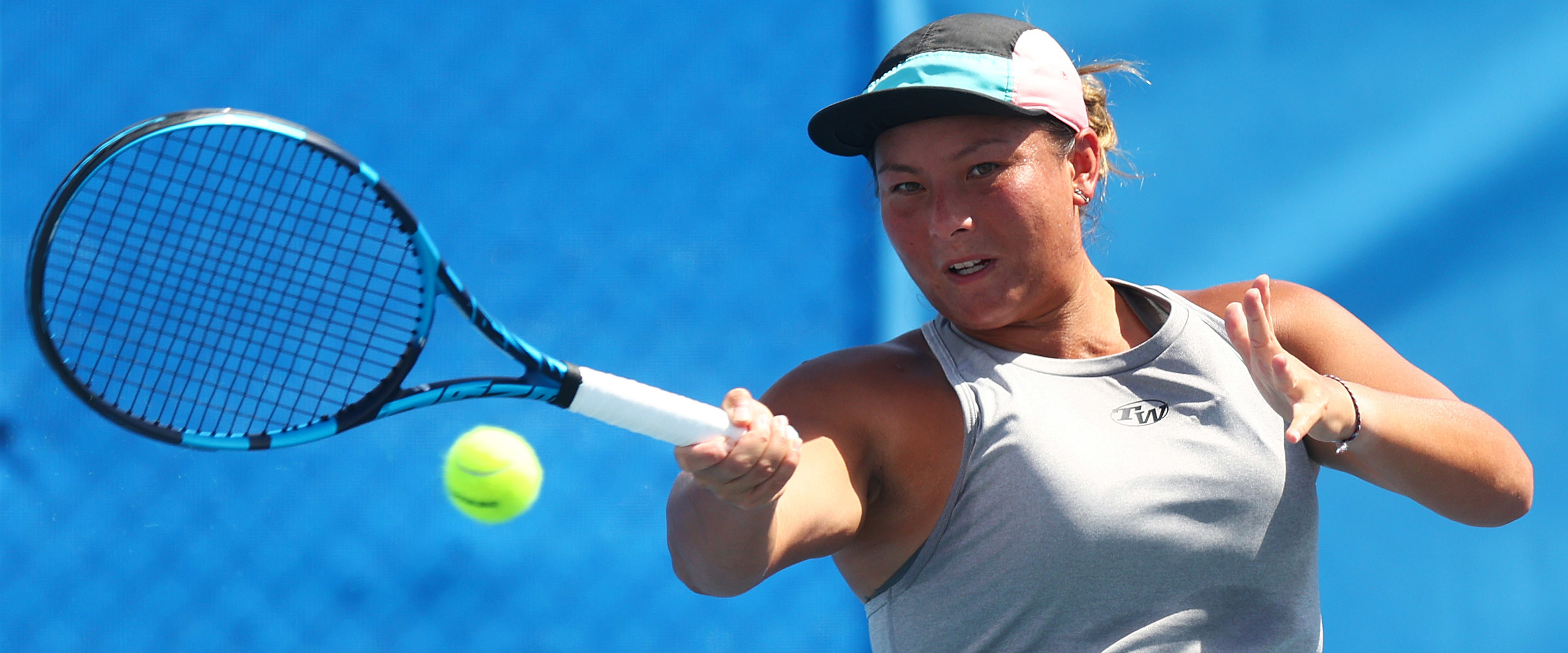 Tara Moore hitting a forehand in a match in 2021