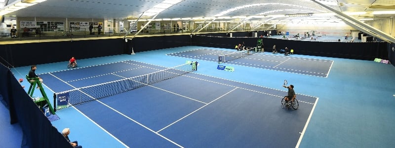 A wheelchair match taking place inside at the National Tennis Centre