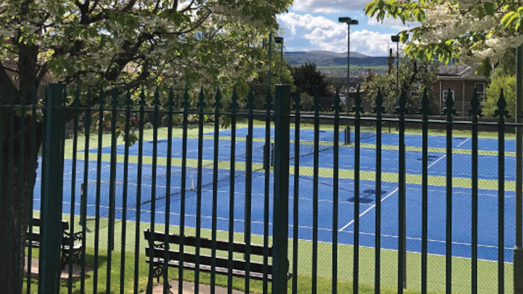 image of three tennis courts taken outside the fence at corstorphine tennis club