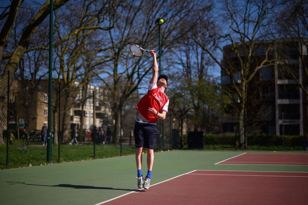 An amateur player hits a serve.jpg