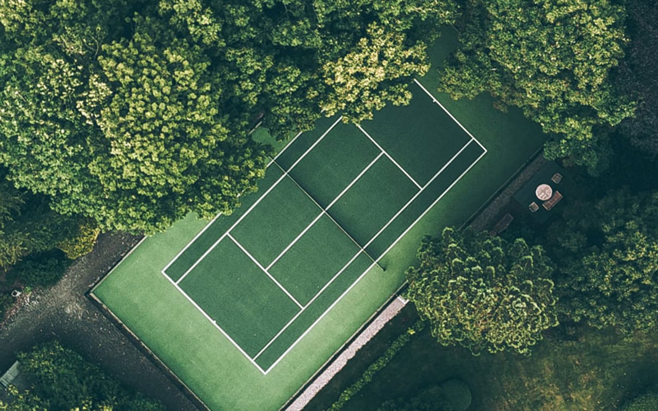 Tennis court situated amongst the trees