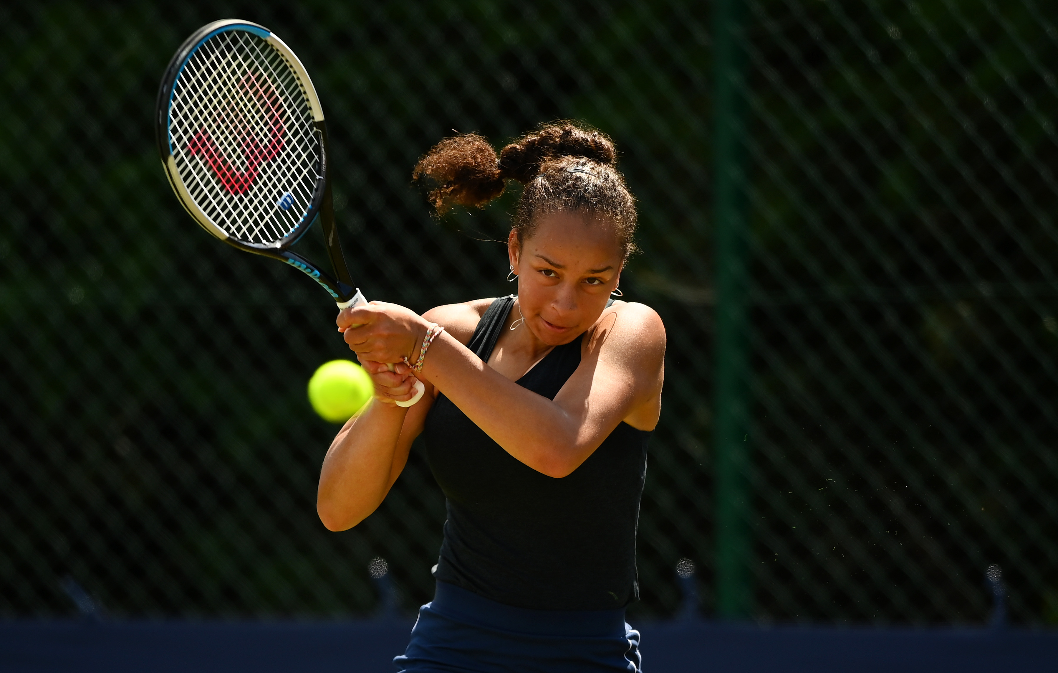 Female tennis player returning a serve