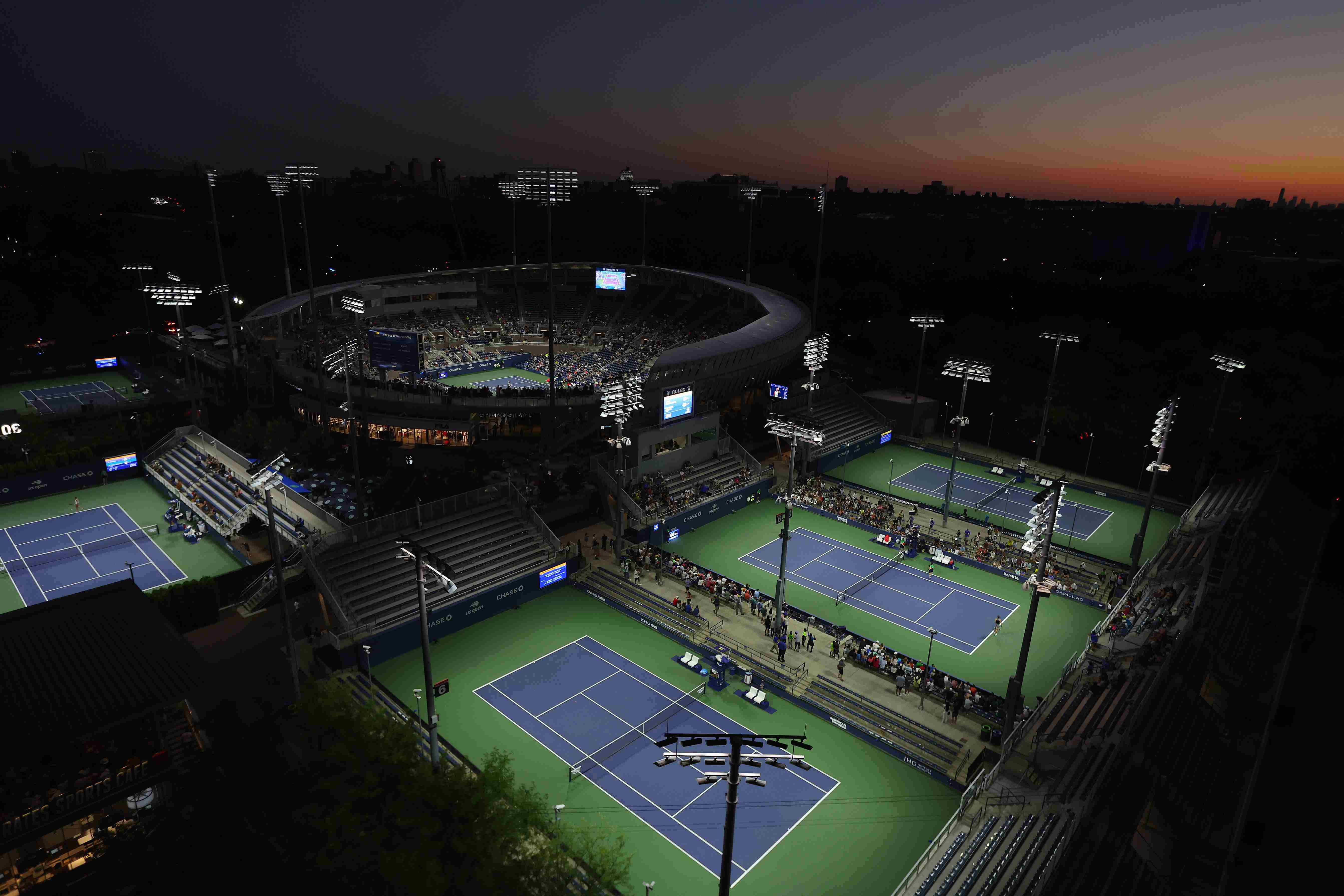 Four tennis courts surrounding Arthur Ashe Stadium at the US Open complex