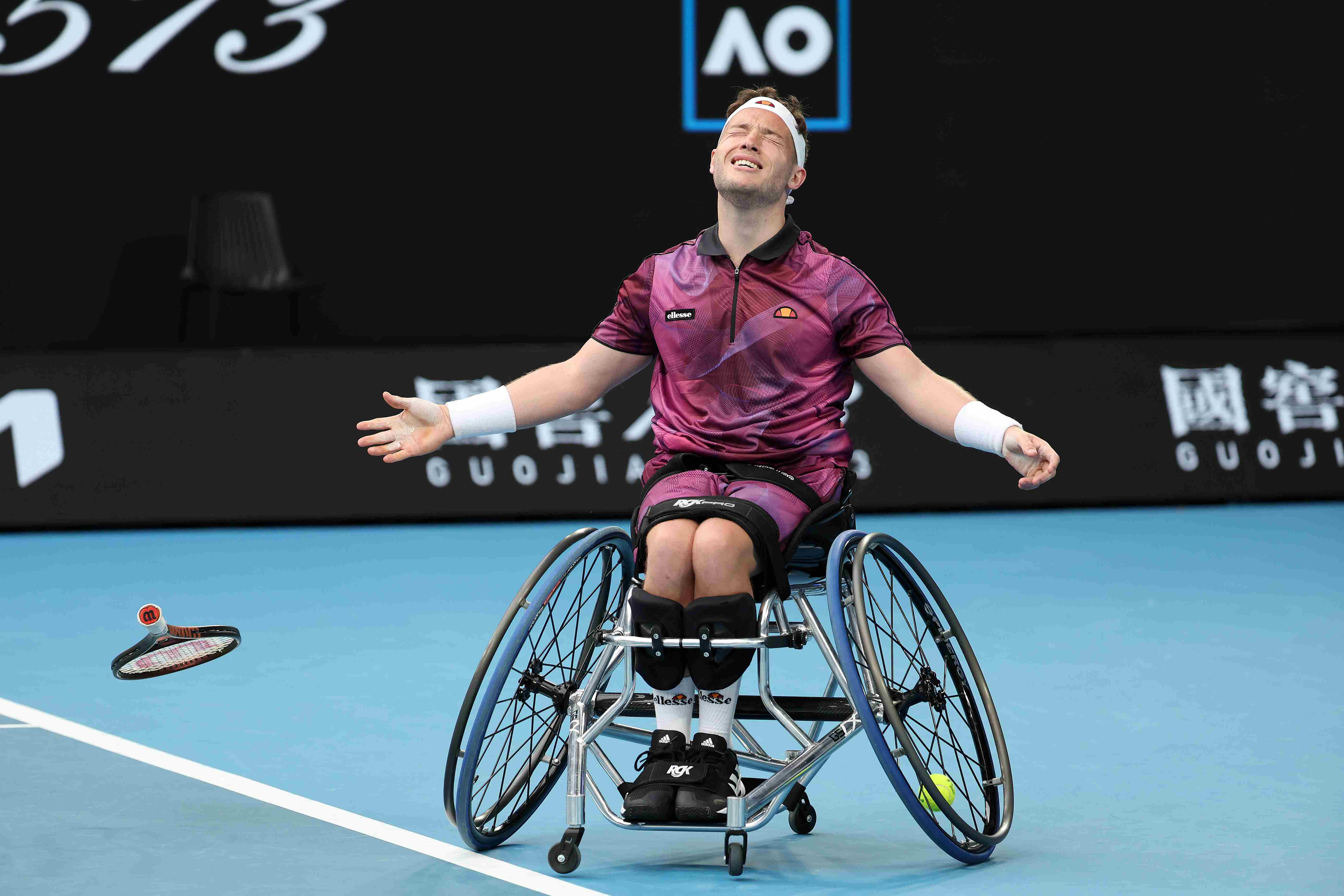 Alfie Hewett drops his racket to the ground as he wins the Australian Open wheelchair singles title