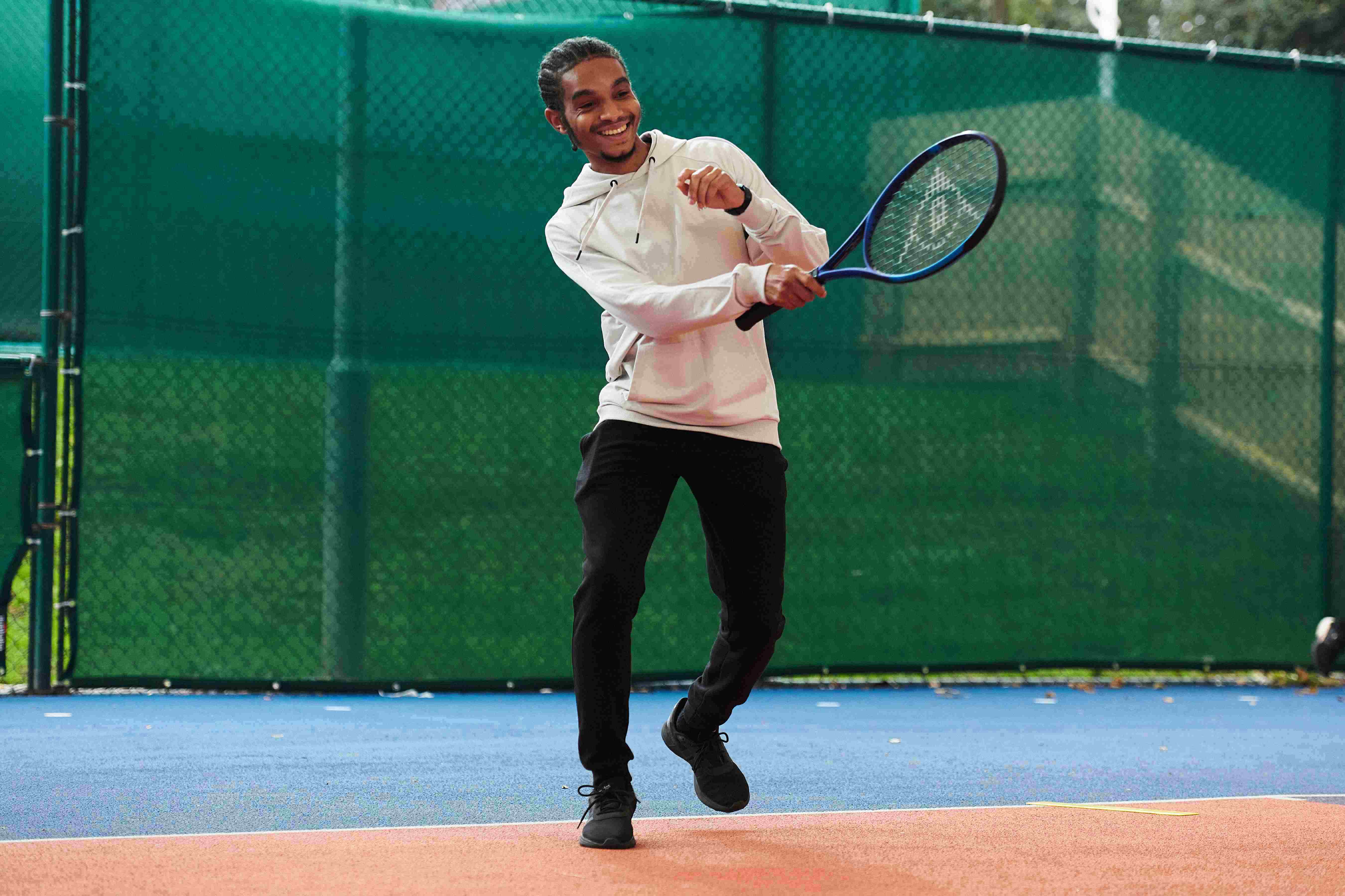 A male tennis player on court at the National Tennis Centre for the Tennis Black List event