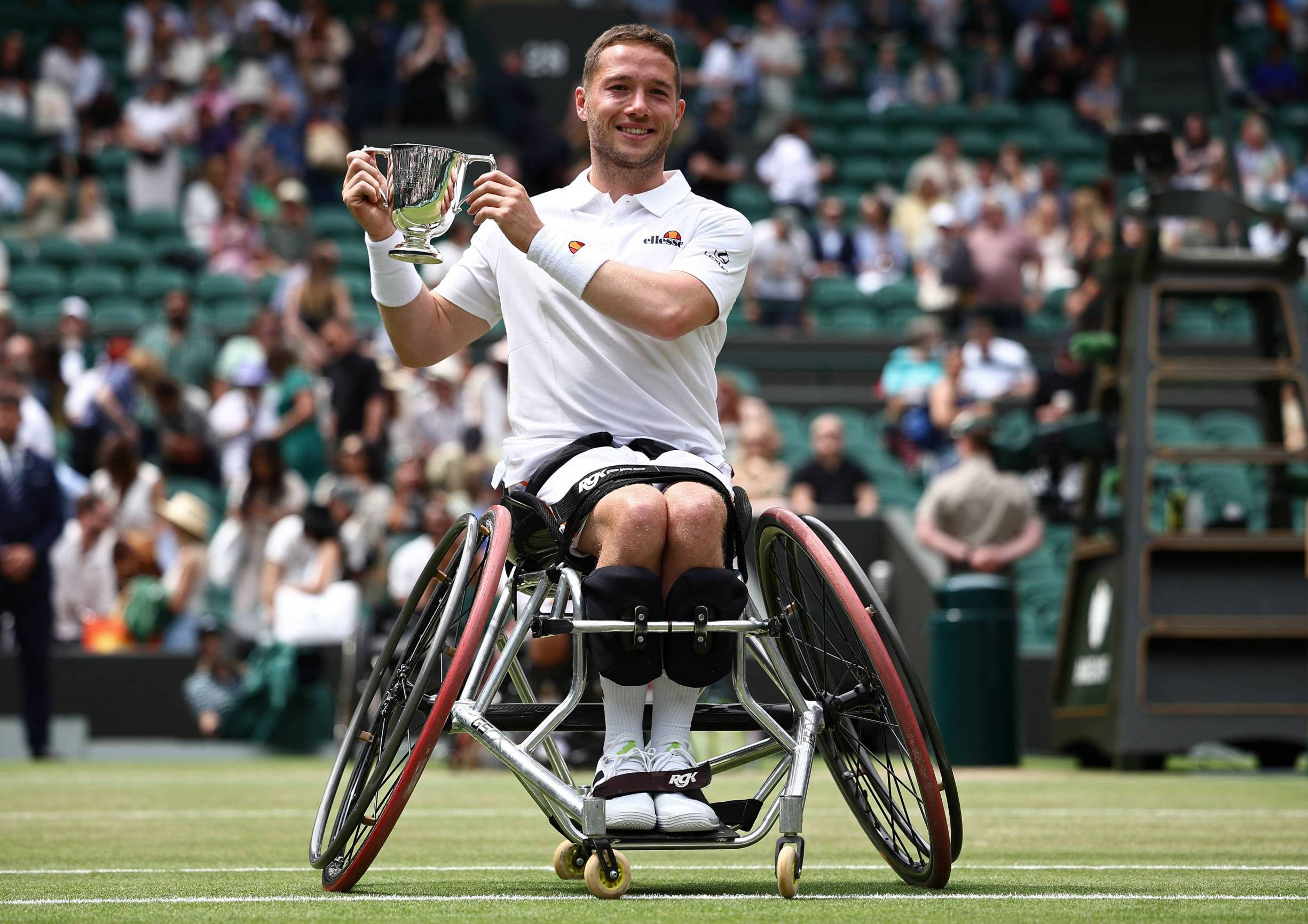 Alfie Hewett holding the Wimbledon men's wheelchair singles title