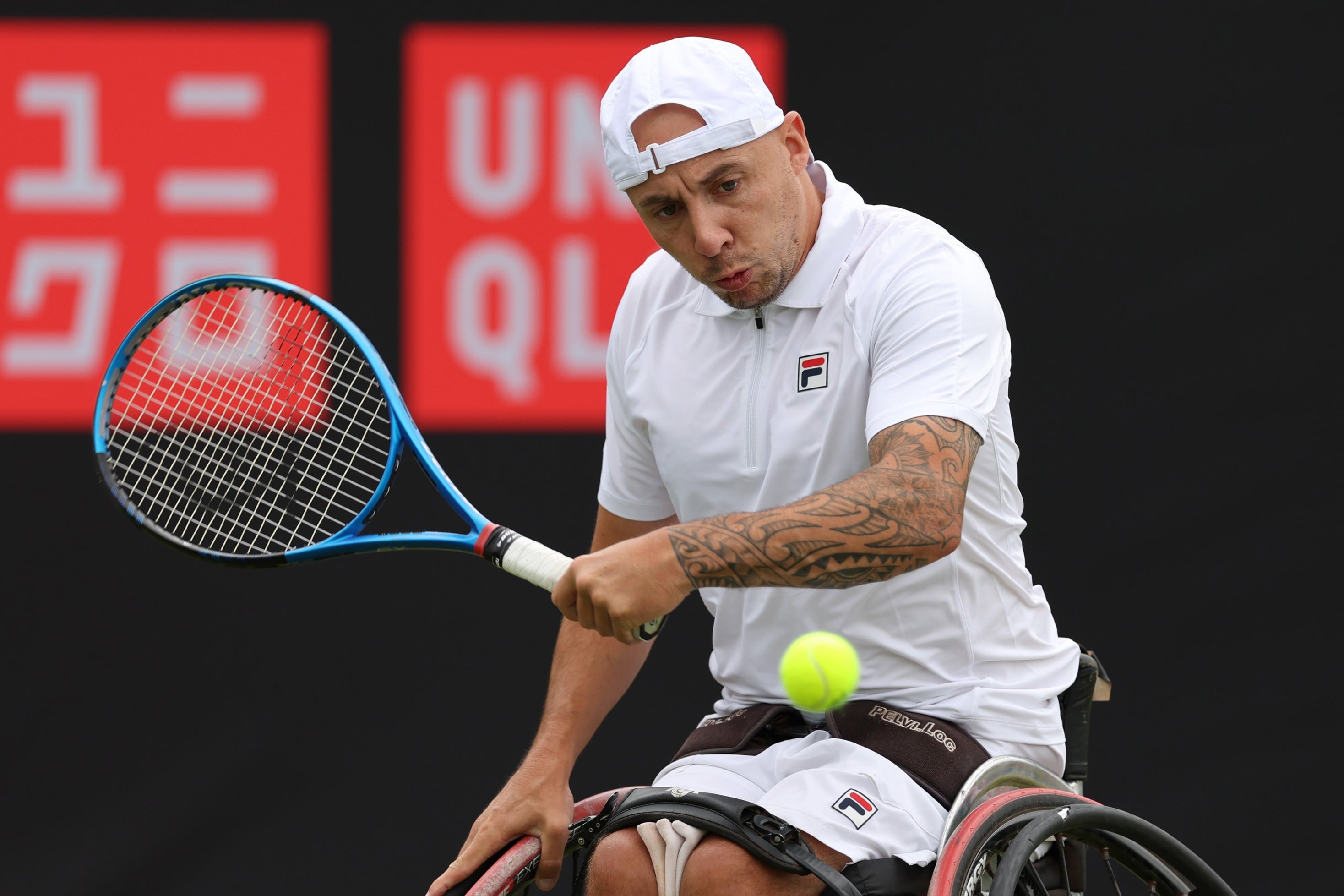 Andy Lapthorne of Great Britain plays a backhand against Heath Davidson of Australia in the Men's Wheelchair Singles match during the Lexus British Open Roehampton at Wimbledon Qualifying and Community Sports Centre on July 02, 2024 in London, England.