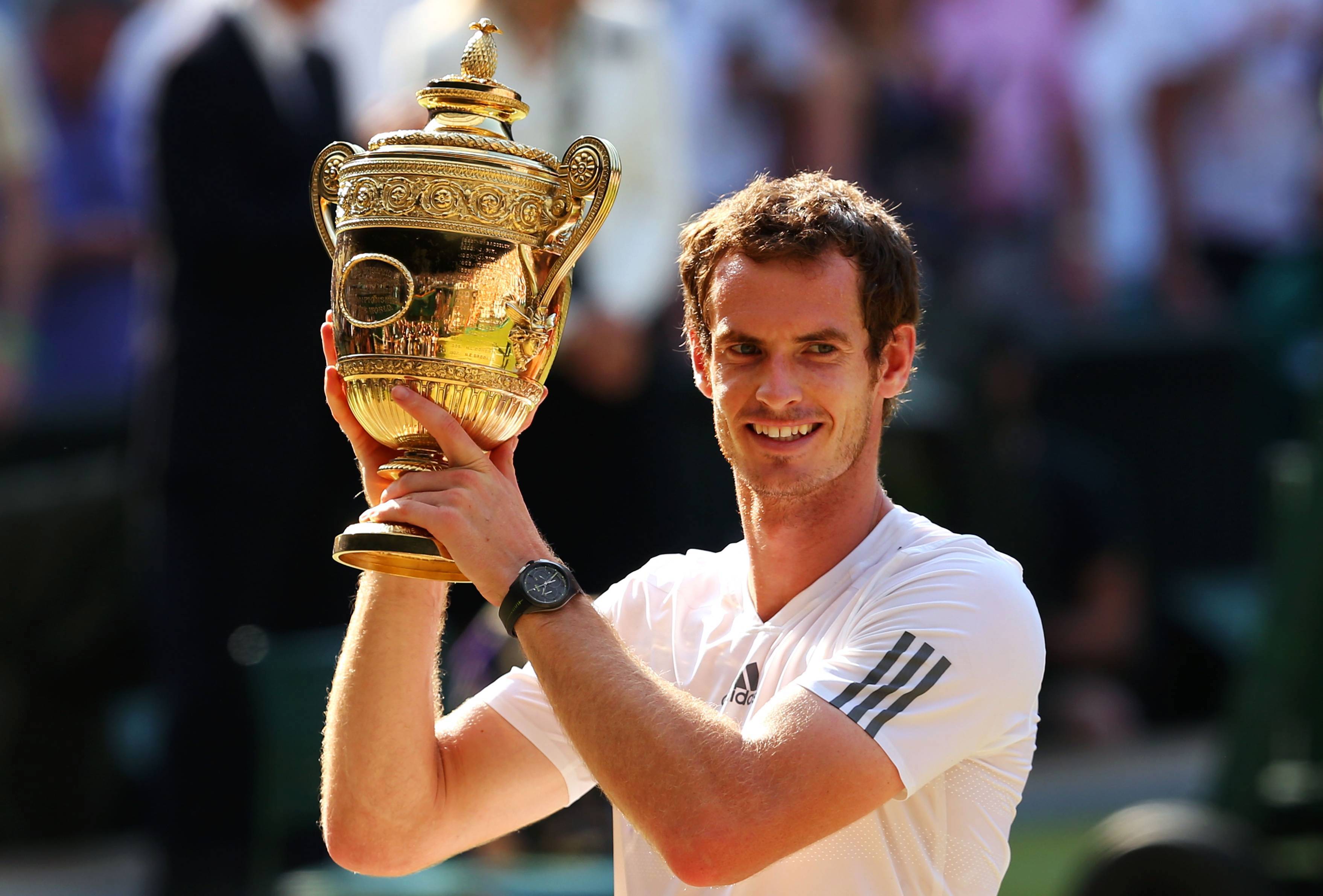 Andy Murray holding his first Wimbledon title in 2013