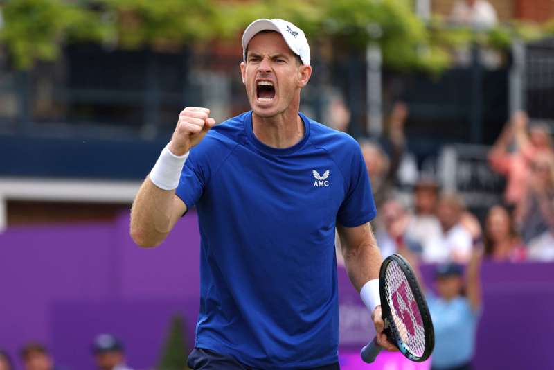 Andy Murray wearing a blue AMC kit while clenching his fist and cheering at the cinch Championships