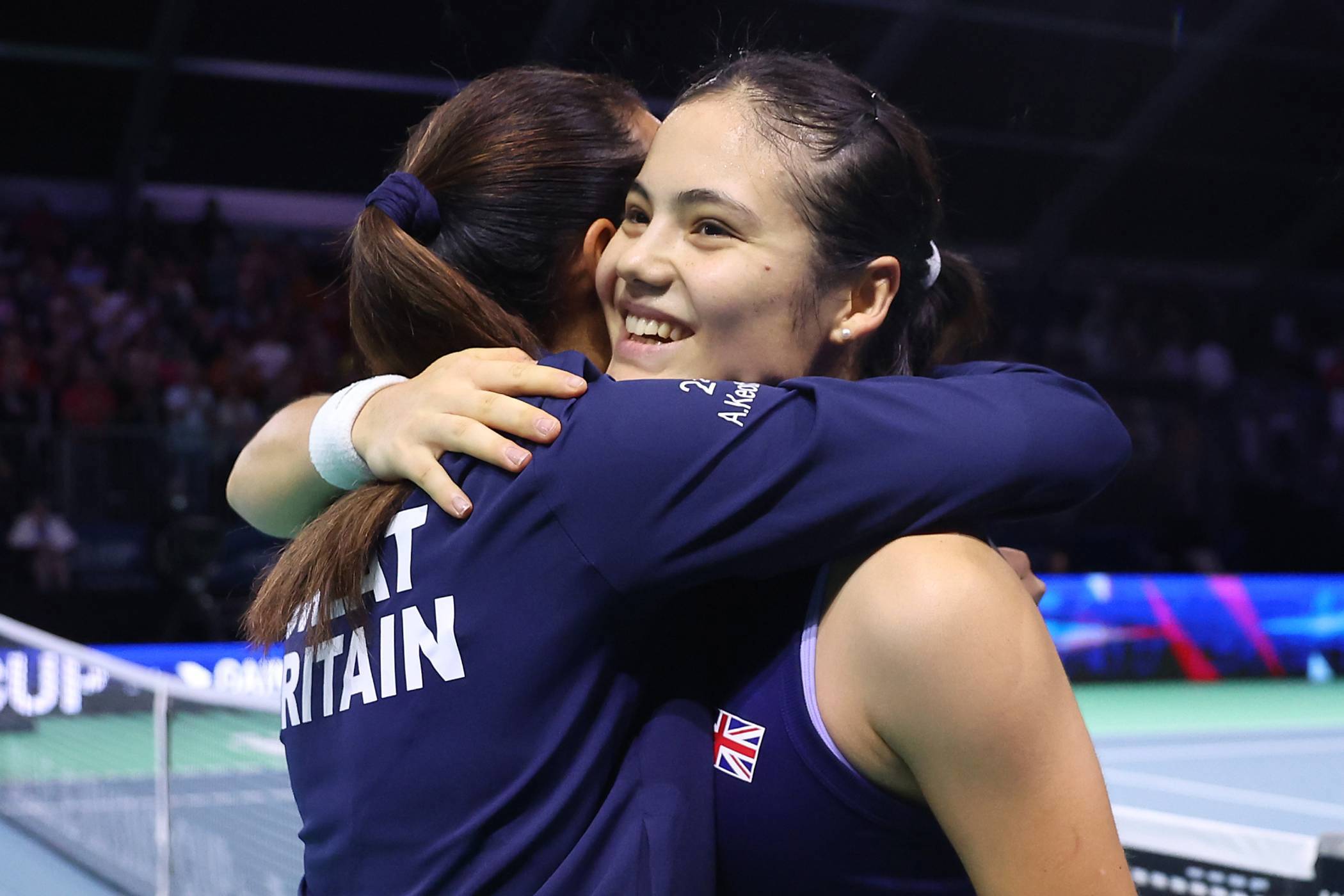 Emma Raducanu and Anne Keothavong hug after Great Britain beat Canada at the Billie Jean King Cup