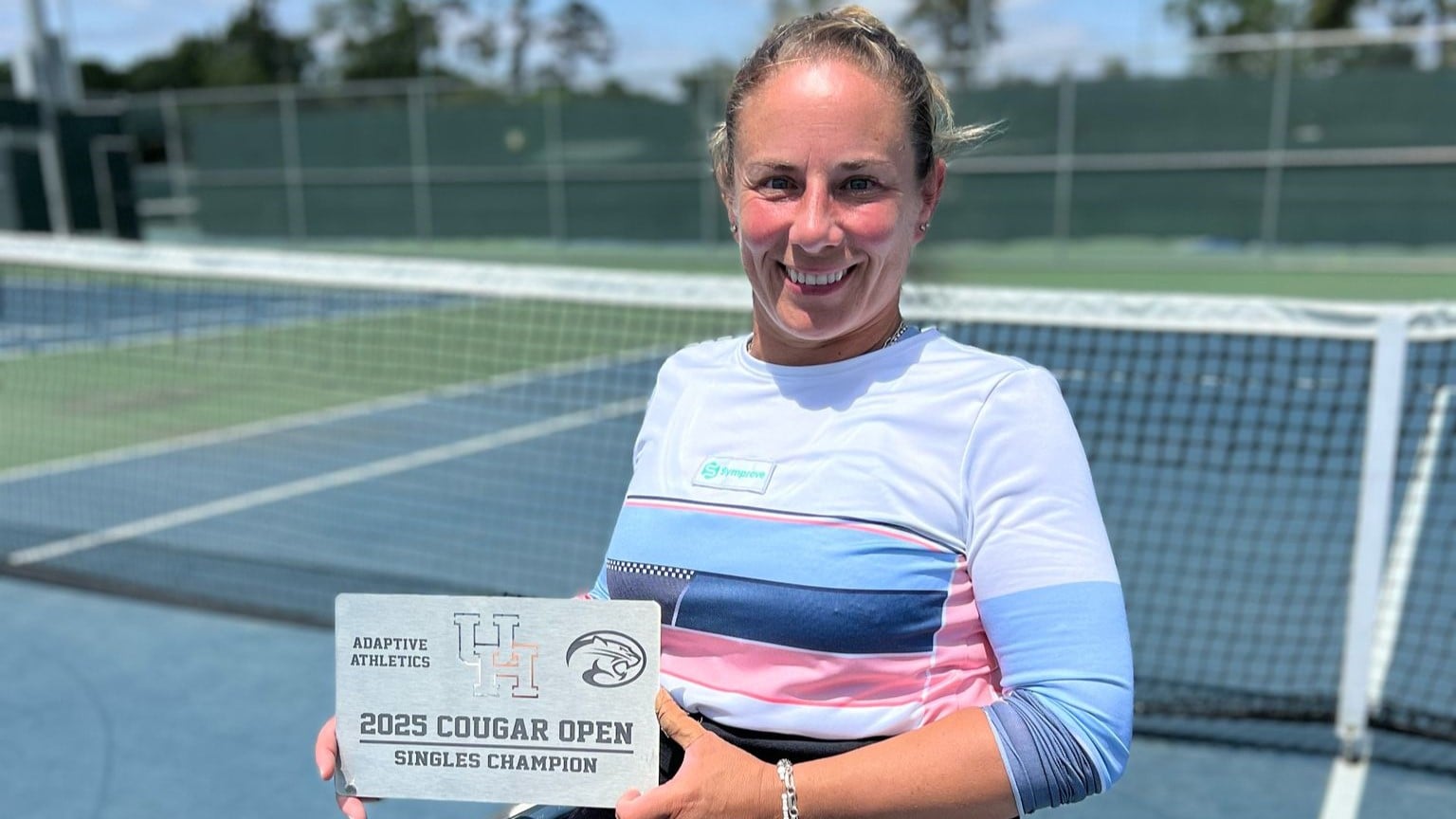 Lucy Shuker smiling while holding the 2025 Cougar Open women's wheelchair singles title