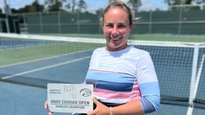 Lucy Shuker smiling while holding the 2025 Cougar Open women's wheelchair singles title