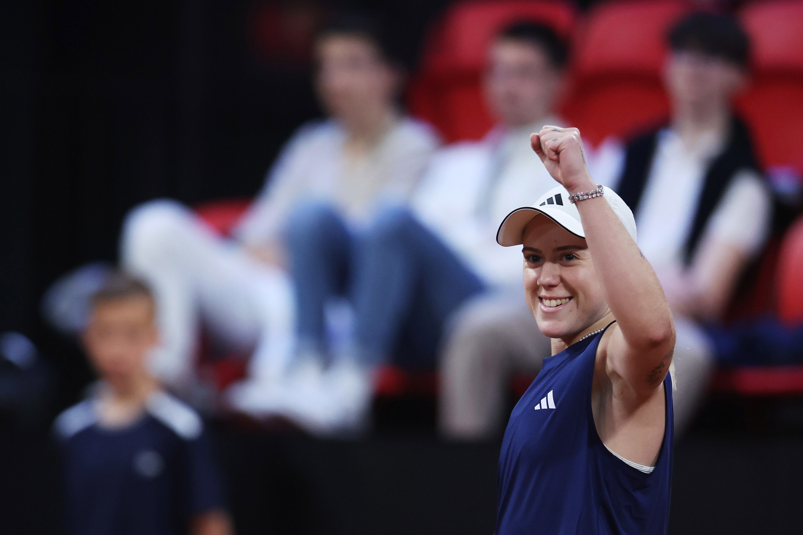 Sonay Kartal raising her arm up in the air and smiling after winning her first match at the Billie Jean King Cup
