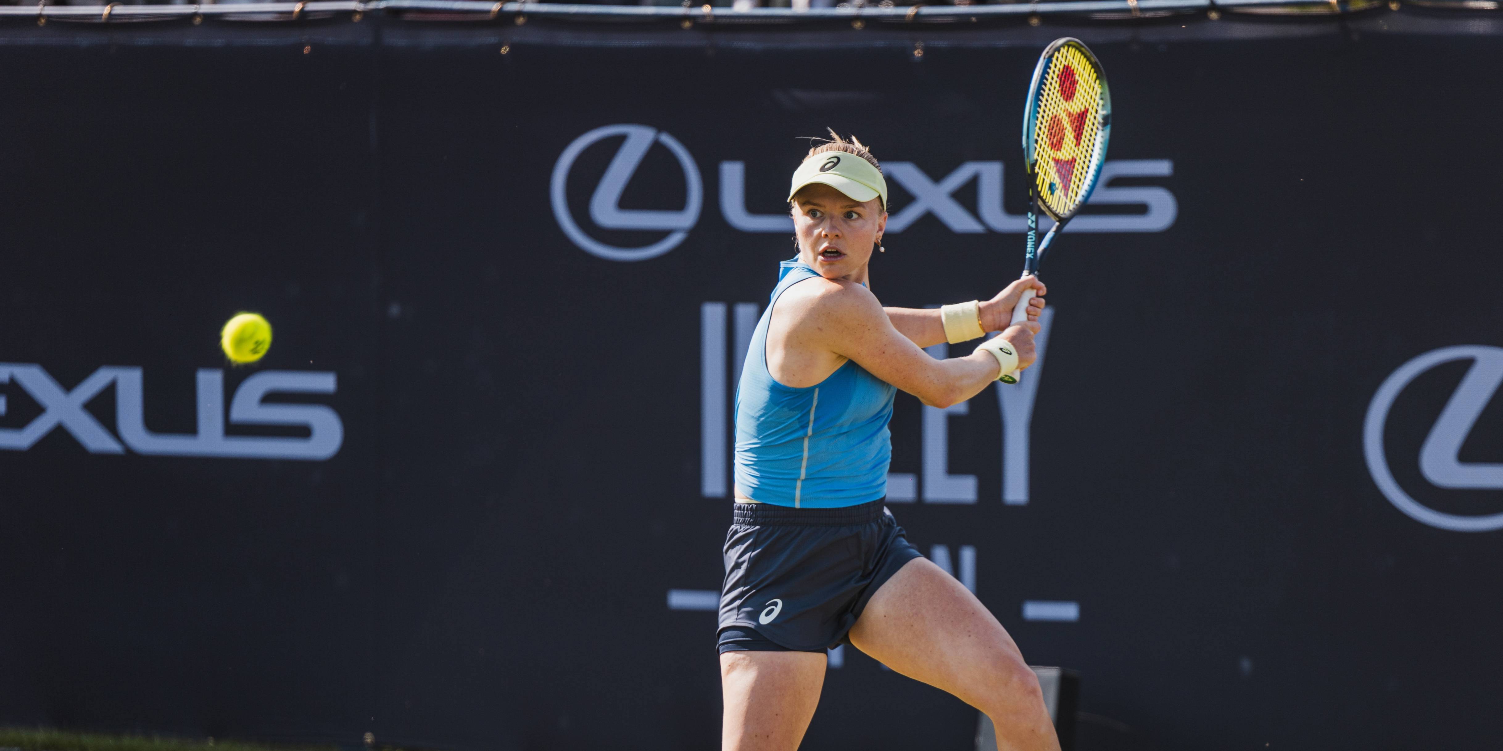 British tennis player Harriet Dart preparing to hit a backhand on court at the Lexus Ilkley Open as a tennis ball comes towards her