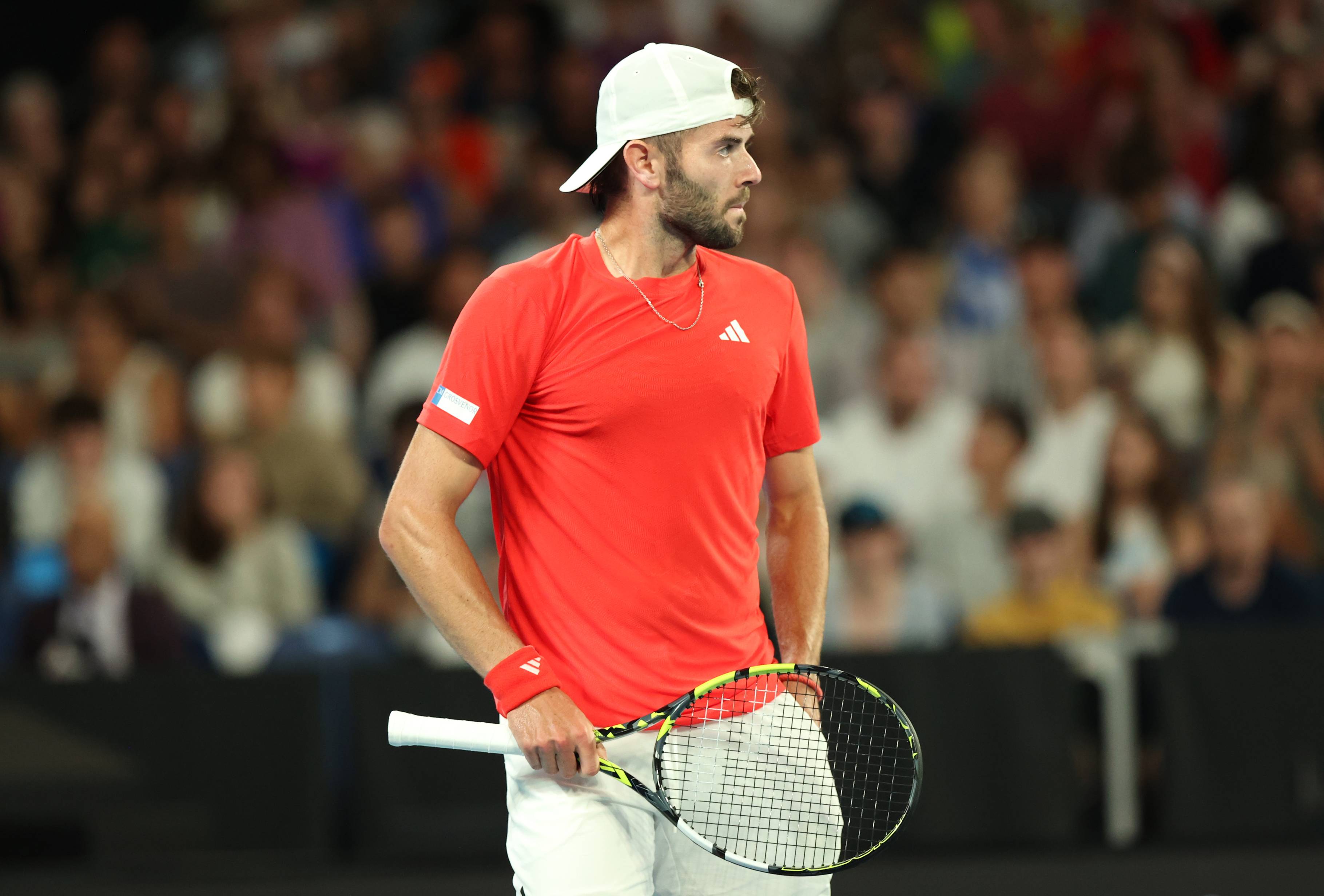 British tennis player Jacob Fearnley holding his racket and looking ahead during his first round match against Nick Kyrgios at the 2025 Australian Open