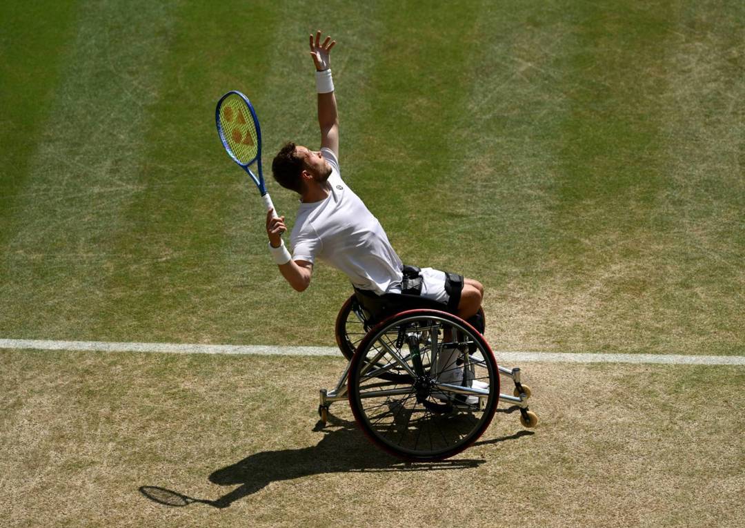 Alfie Hewett hits a serve during the final of the men's wheelchair singles at Wimbledon