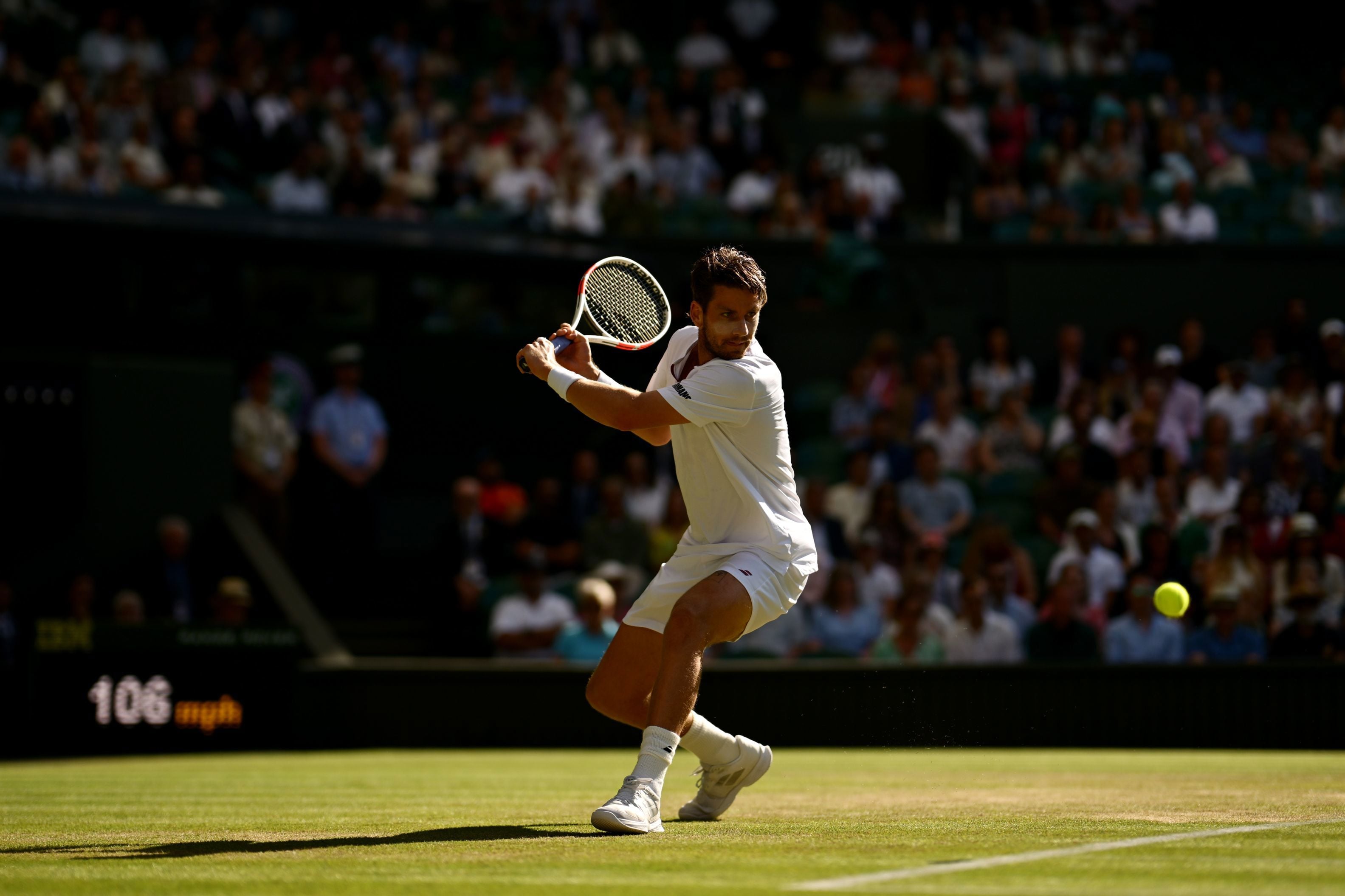 Cam Norrie about to hit a back hand in front of the Wimbledon crowd