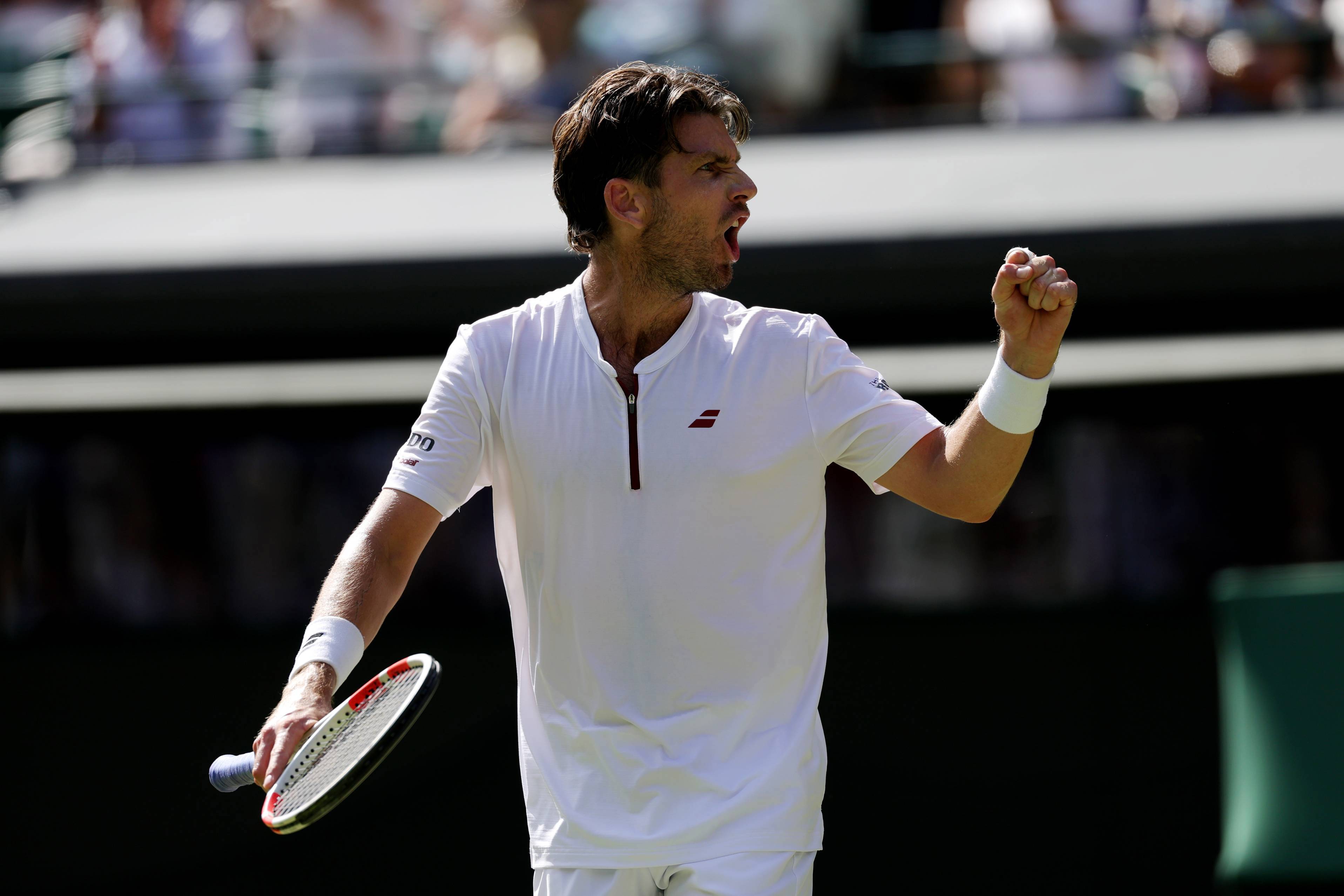 Cam Norrie pumping his fist in celebration at Wimbledon