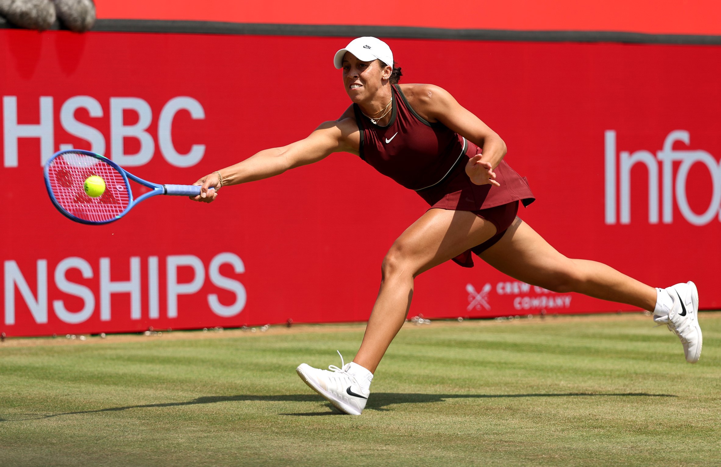 Madison Keys reaching for a forehand on the grass at the HSBC Championships