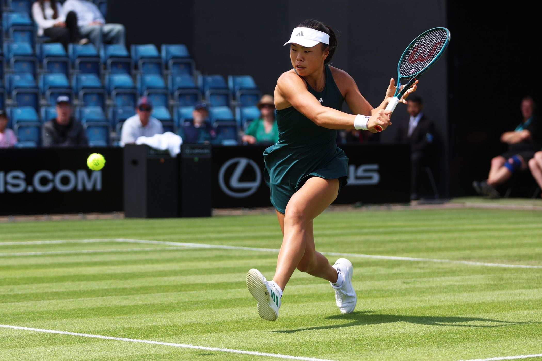 Mimi Xu about to hit a low backhand on the grass at the Lexus Birmingham Open