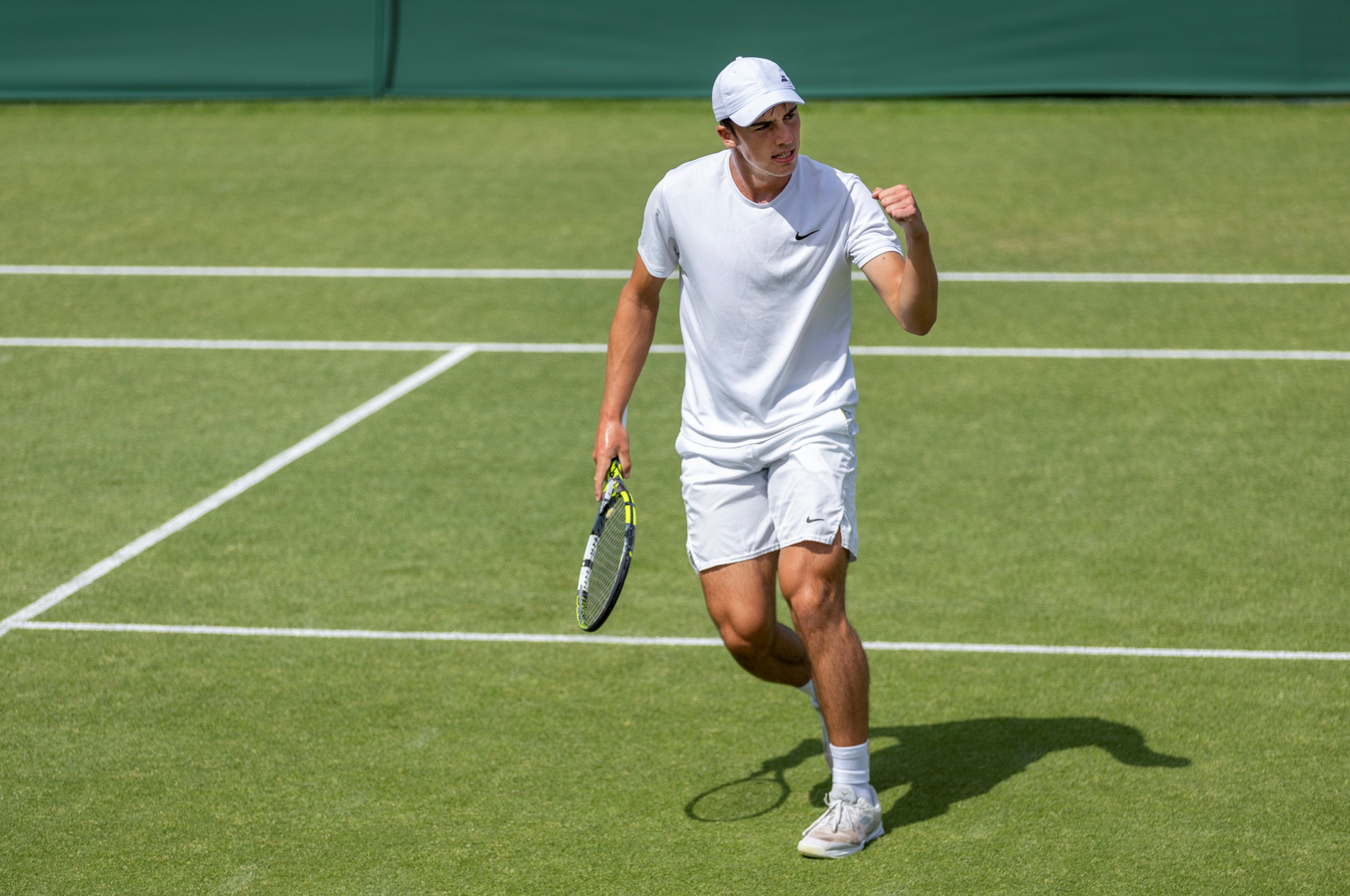 Oliver Tarvet celebrates on the grass court after his Wimebldon qualifying win