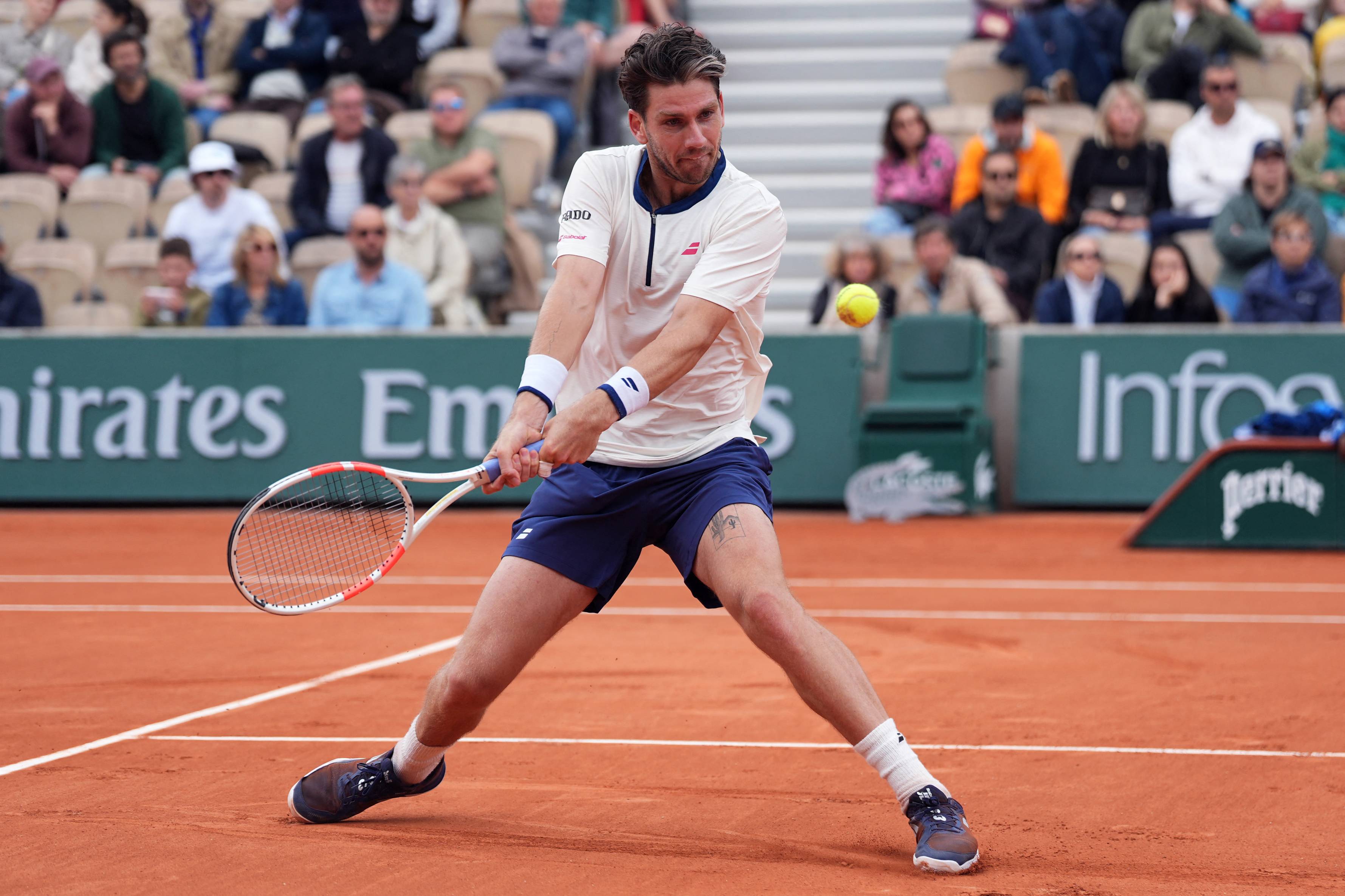 Cam Norrie hits a backhand against Daniil Medvedev in the opening round at Roland Garros