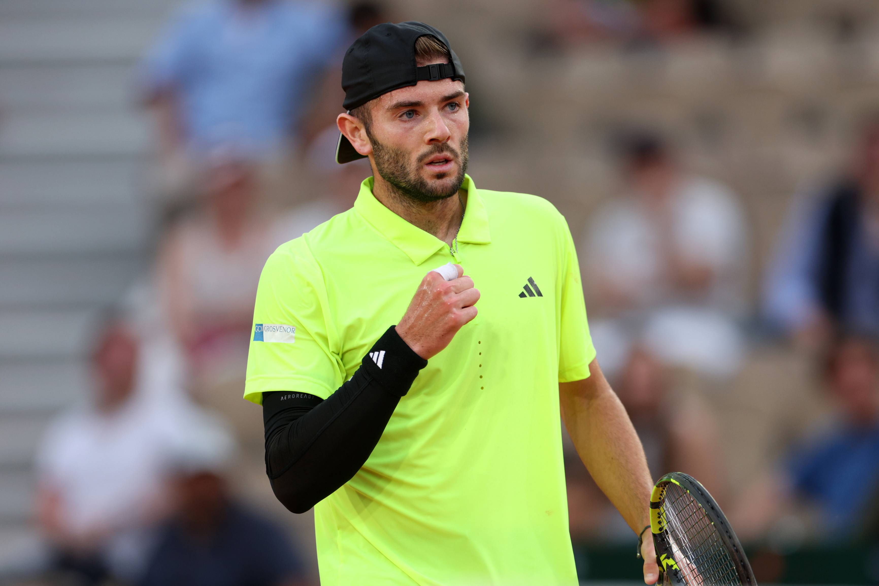 Jacob Fearnley pumps his fist in celebration during his second round match at Roland Garros