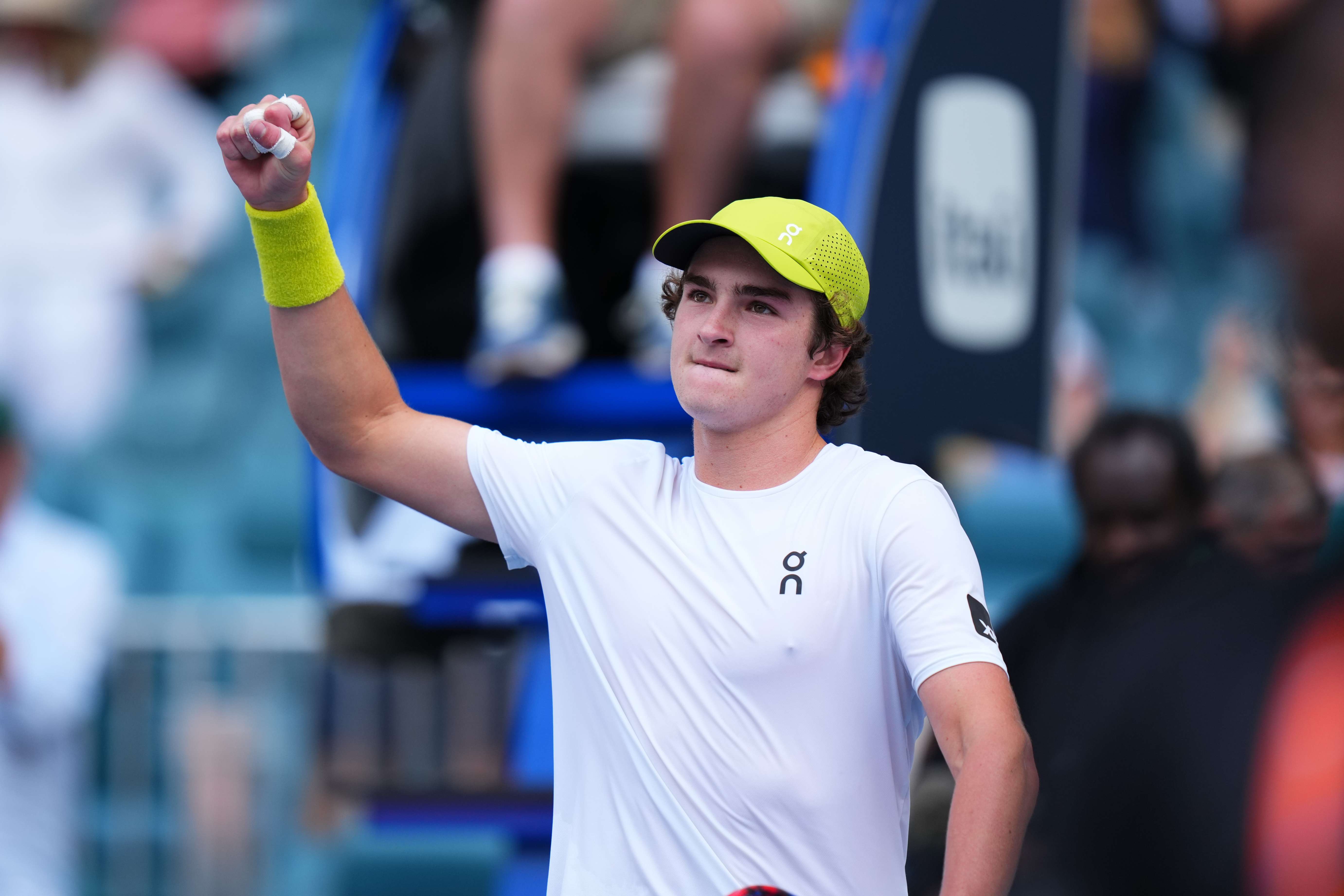 Brazilian tennis star Joao Fonseca holding his fist in the air in celebration