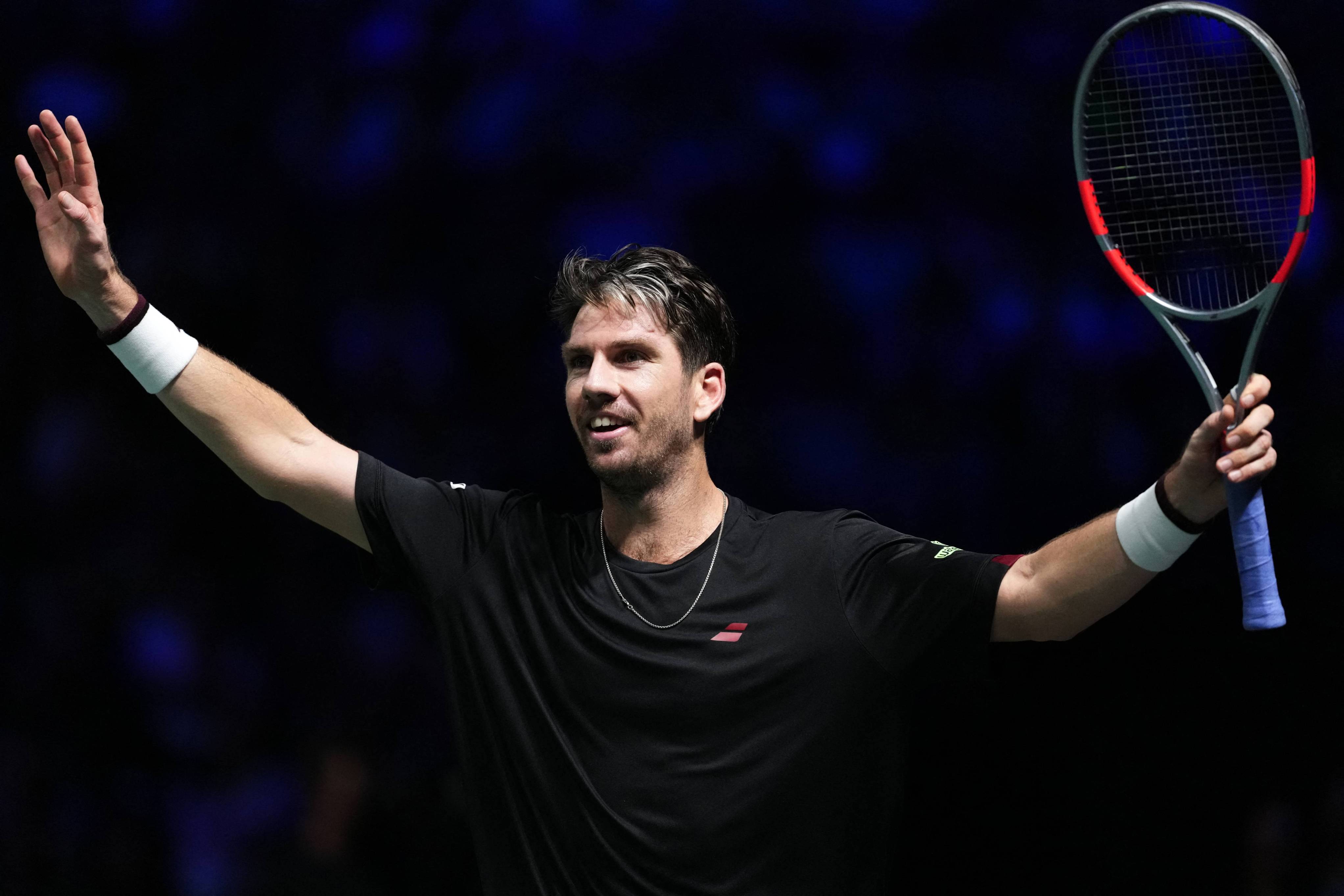 Cam Norrie celebrates defeating Carlos Alcaraz at the Rolex Paris Masters