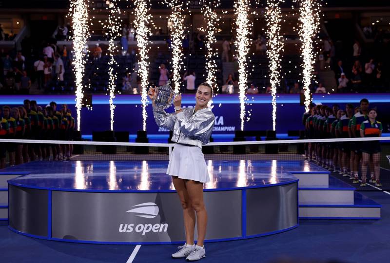 Aryna Sabalenka holding the 2025 US Open women's singles trophy