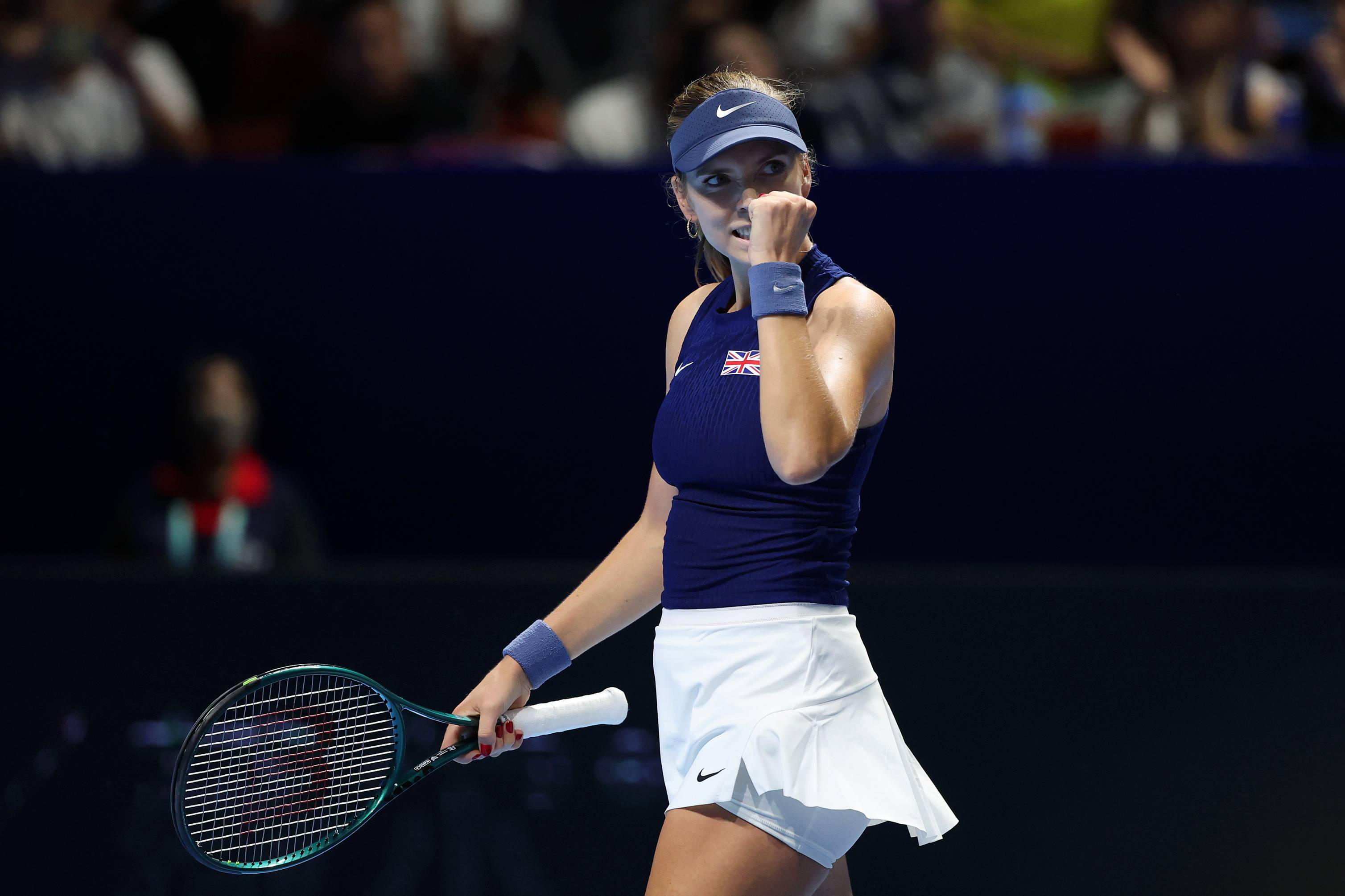 British tennis player Katie Boulter clenching her fist on court after winning a point during Great Britain's Billie Jean King Cup tie against Japan