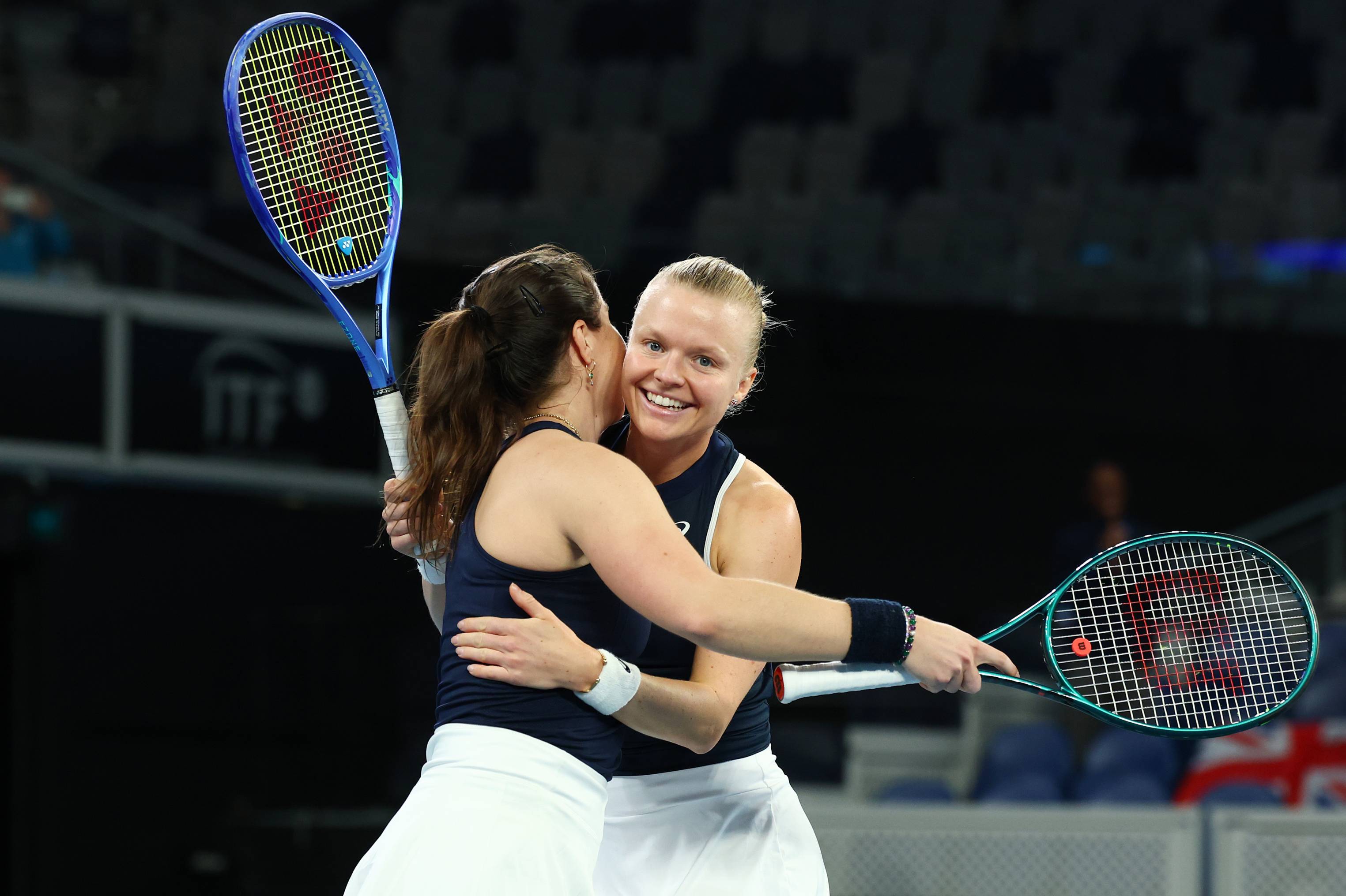 Harriet Dart and Jodie Burrage hug in celebration after beating Australia at the Billie Jean King Cup