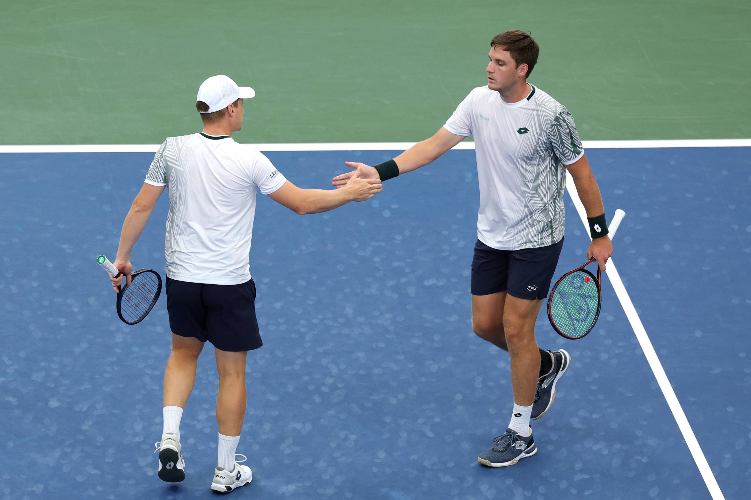 Henry Patten and Harri Heliovaara high five during a second round win at the 2026 US Open