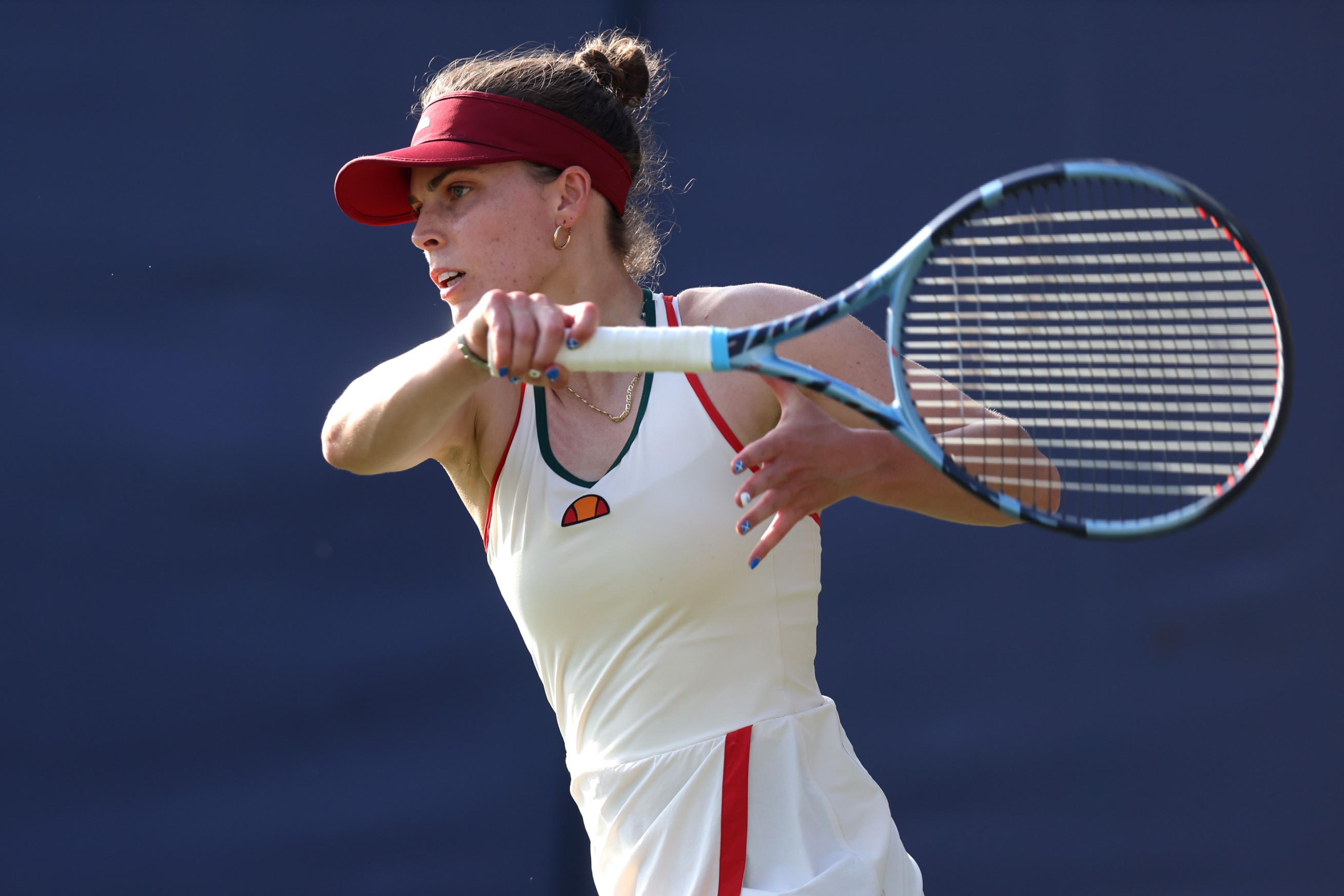 British doubles star Maia Lumsden hits a forehand during a tennis match