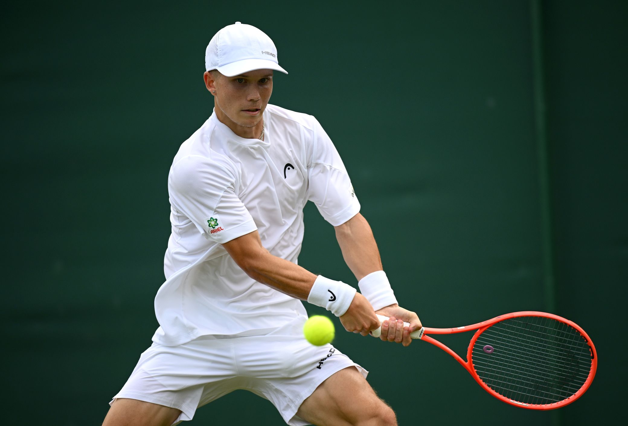 Harry Wendelken about to hit a backhand at Wimbledon