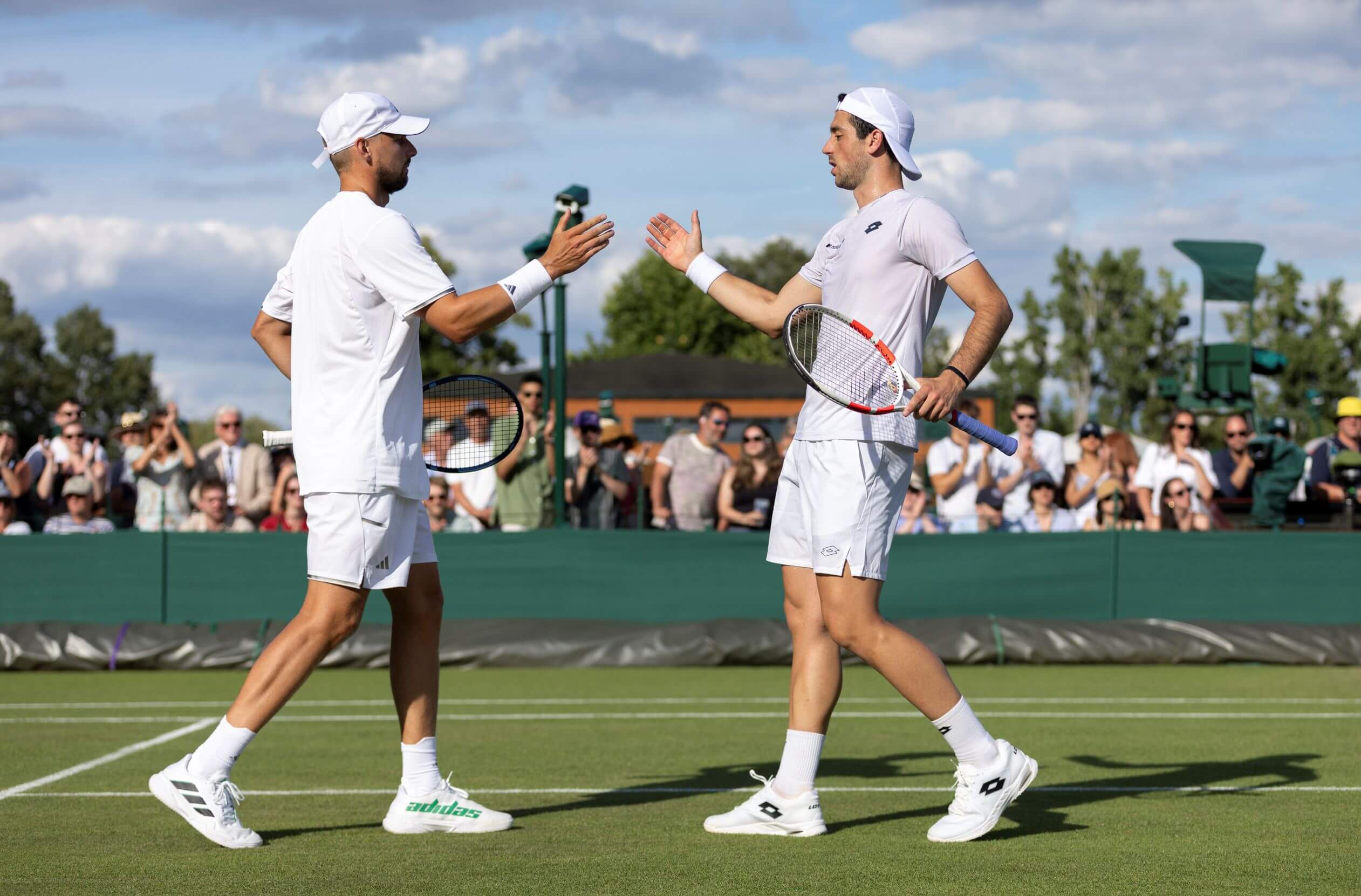 Julian Cash and Lloyd Glasspool high five after a point at Wimbledon