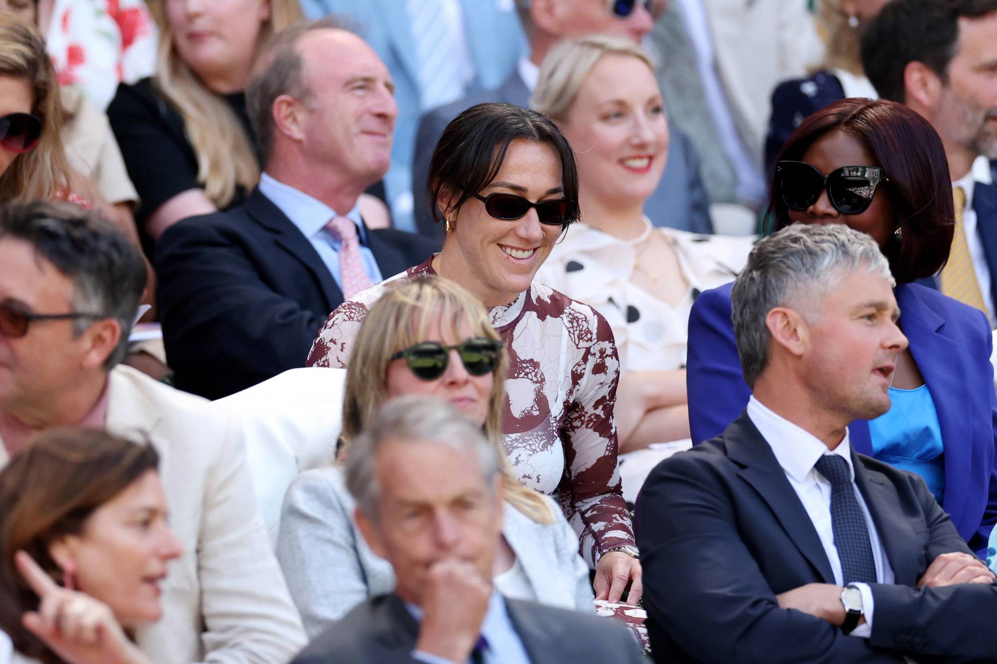Professional football player Lucy Bronze smiling while watching tennis at Wimbledon