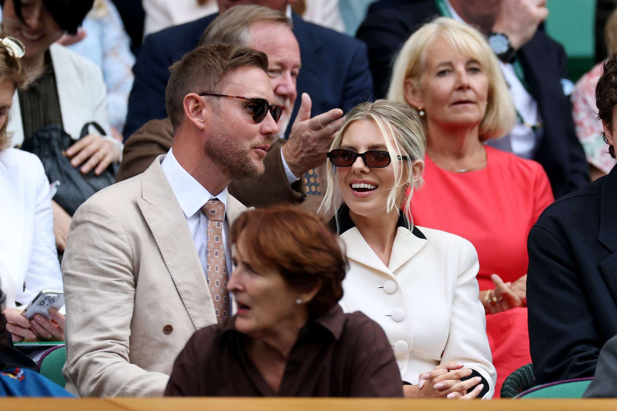 Cricketer Stuart Broad talking to his partner Mollie King in the Royal Box at Centre Court