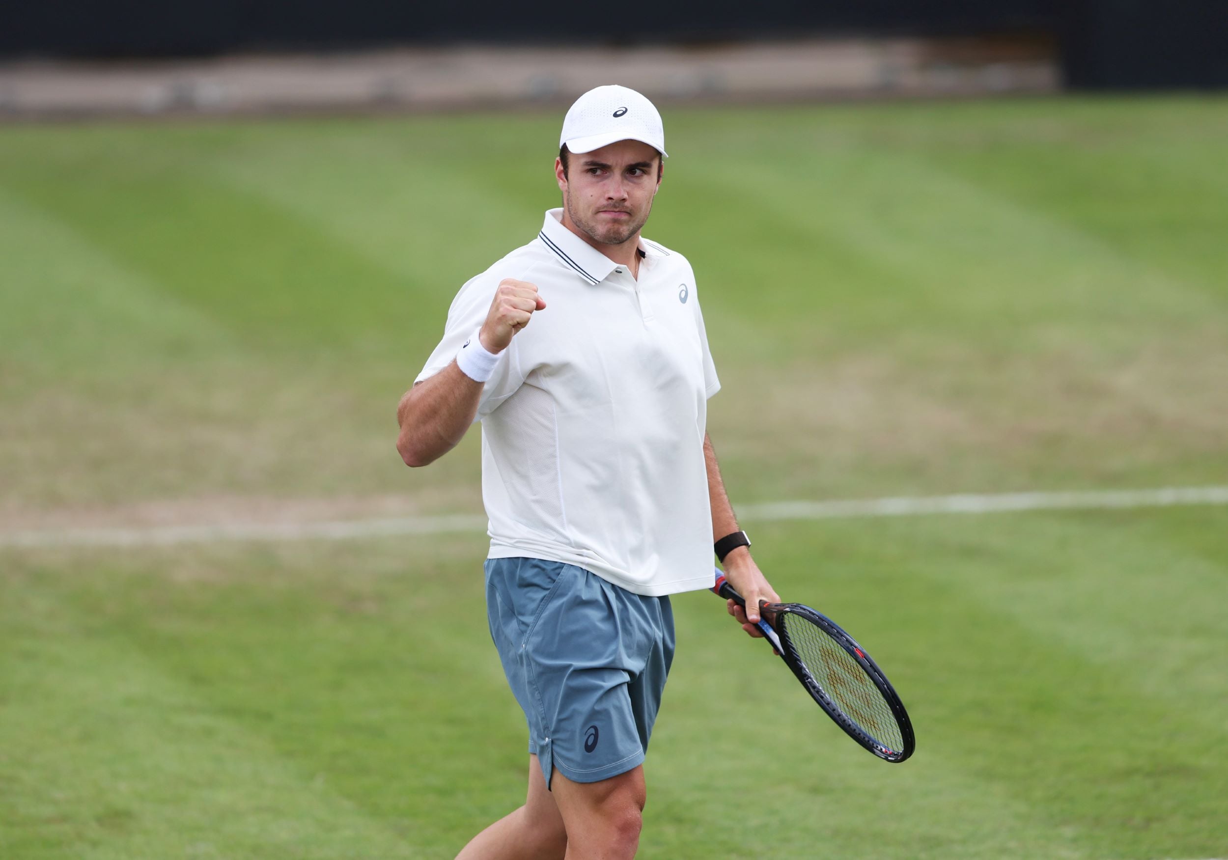 Arthur Fery pumps his fist in celebration after winning a point in the first round of Lexus Birmingham Open