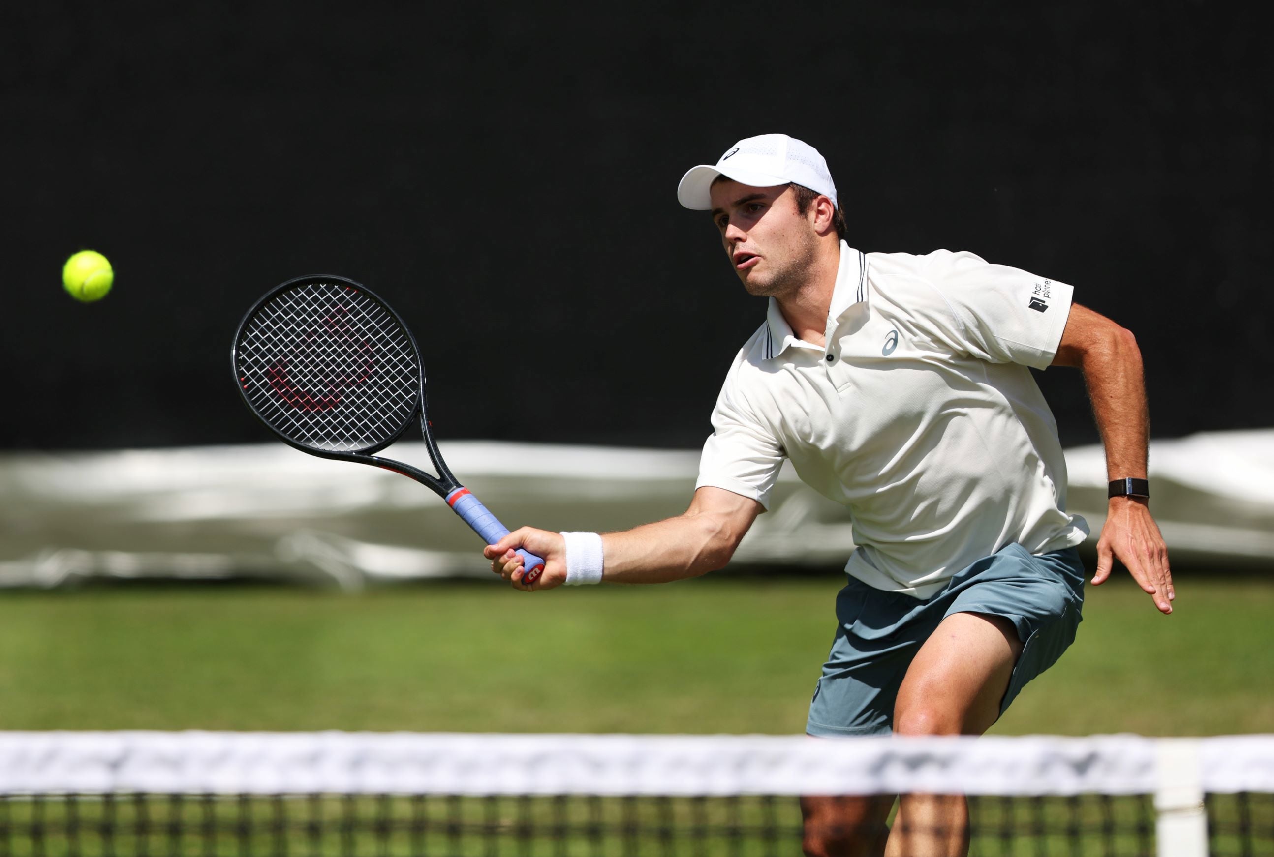 British tennis player Arthur Fery hitting a volley over the net