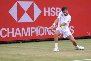Cam Norrie bending down to hit a backhand on court at the HSBC Championships