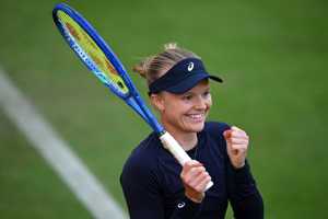 Britain's Harriet Dart smiling, holding her racket in one hand and clenching her fist after winning her first round match at the HSBC Championships