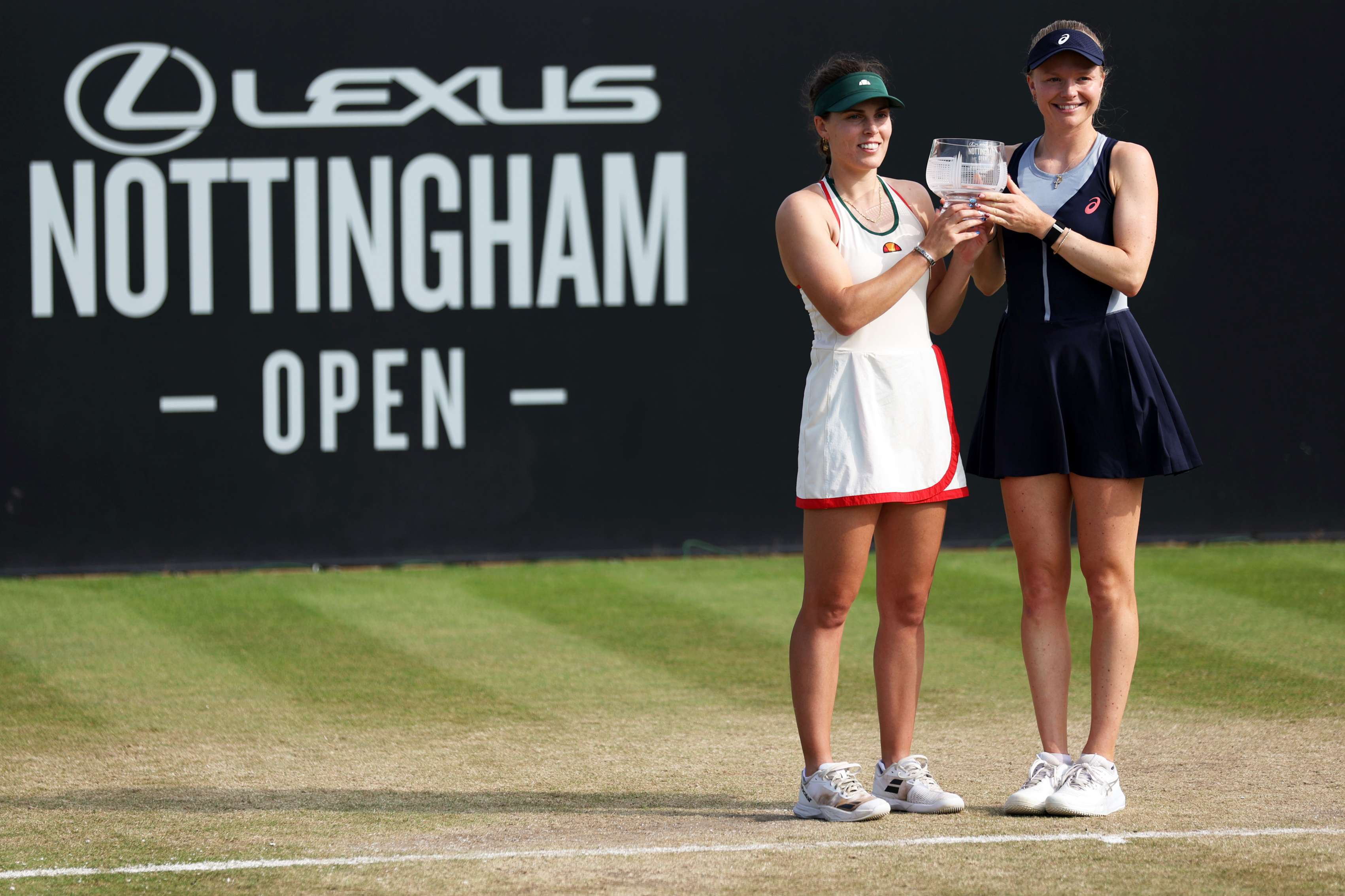 Harriet Dart and Maia Lumsden holding the Lexus Nottingham Open doubles trophy on court 
