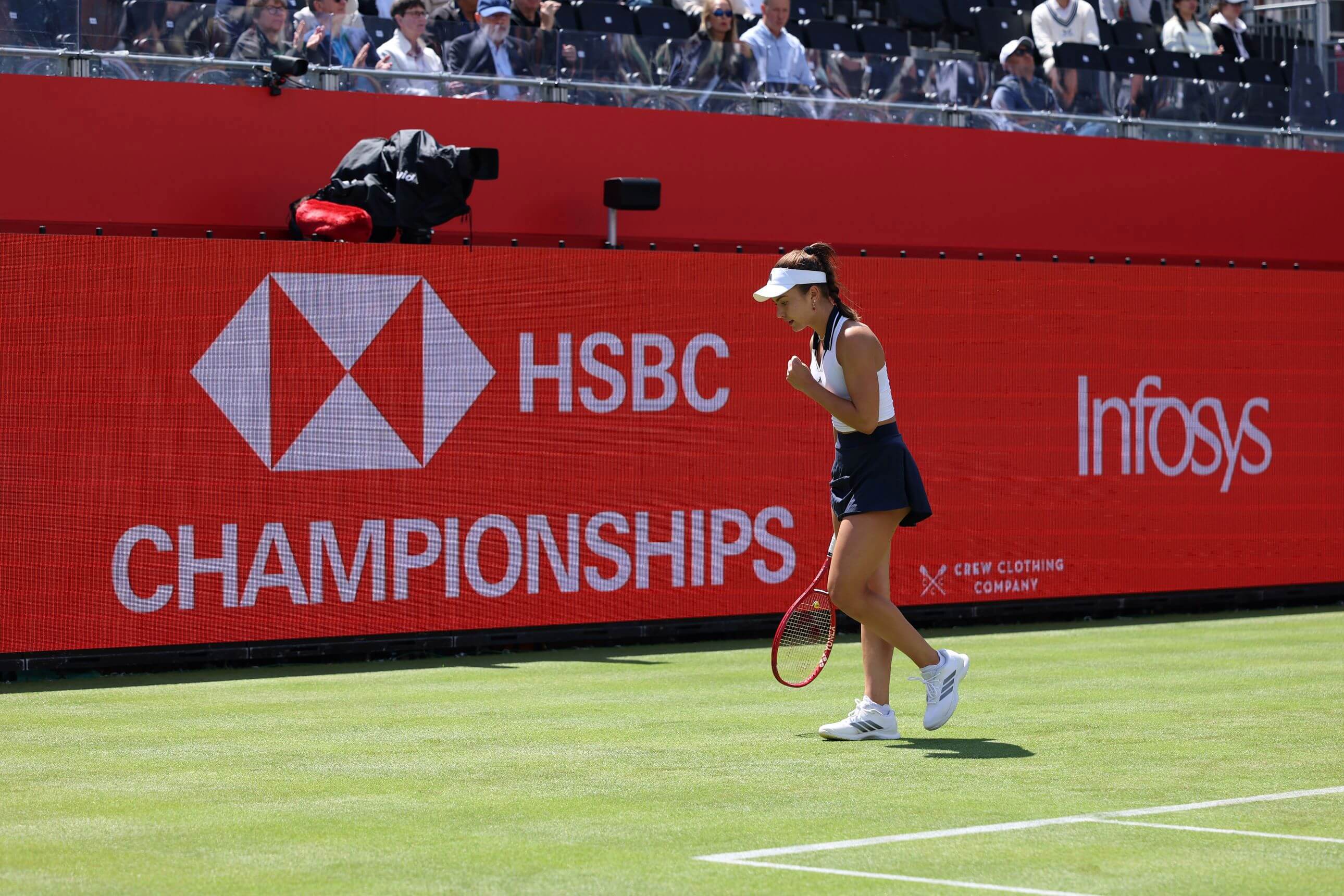 Tennis player Iva Jovic pumps fist and cheers in celebration on court at the HSBC Championships