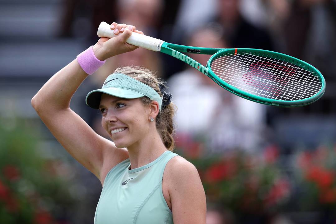 Katie Boulter waves her racket to the crowd after winning in the first round of the HSBC Championships