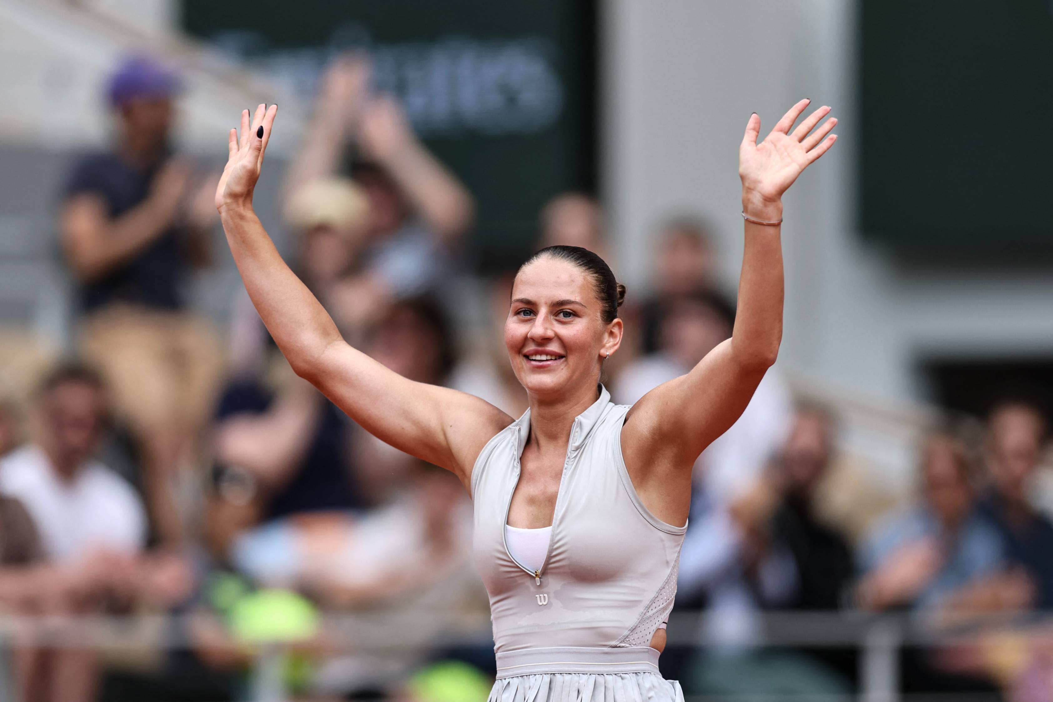 Ukrainian tennis player Marta Kostyuk waving to the crowd on court at Roland Garros 