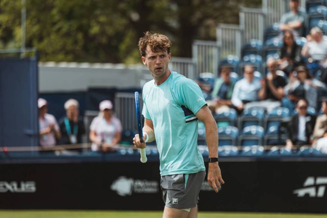 Max Basing holding his tennis racket on court at the Lexus Ilkley Open
