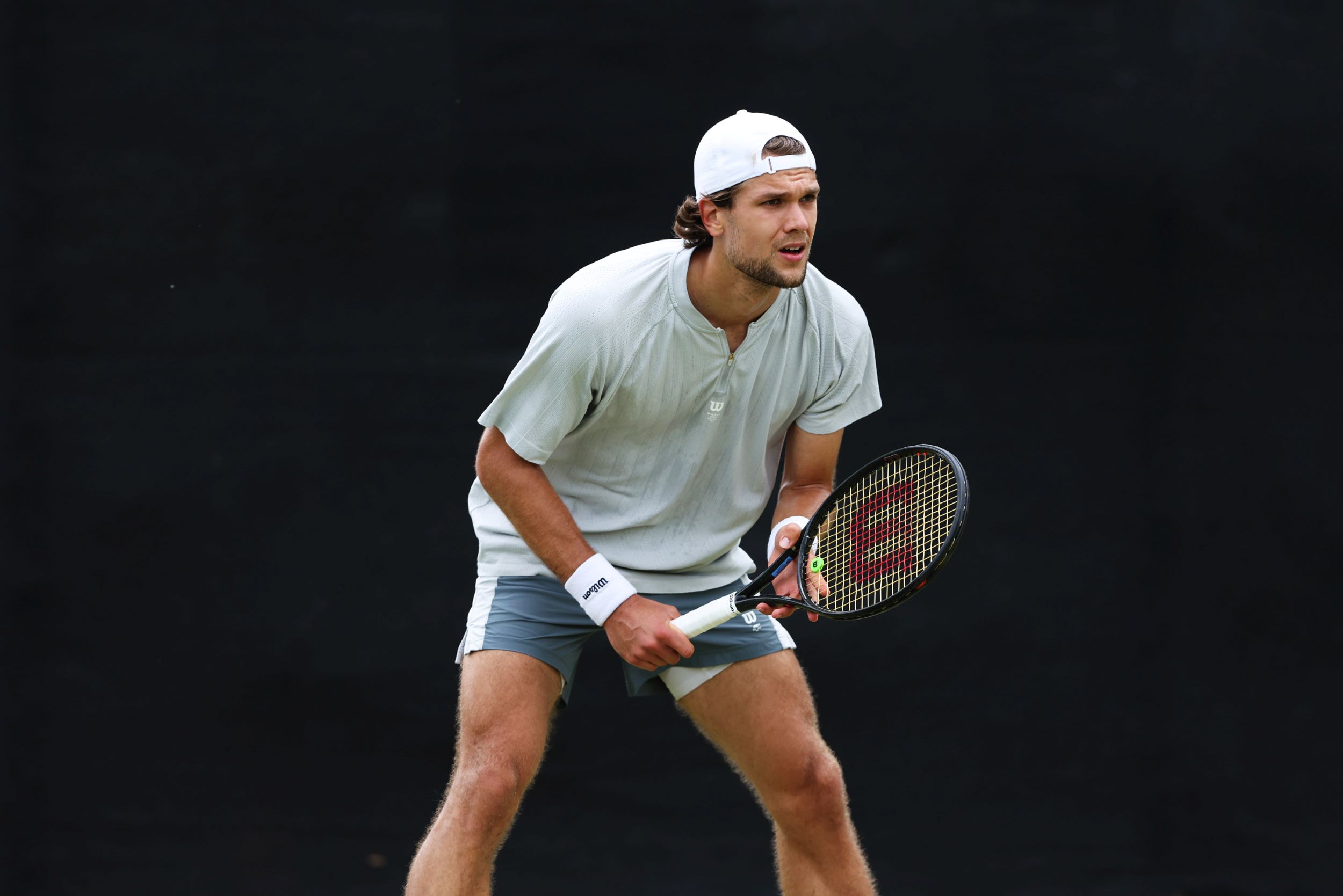 Otto Virtanen standing, ready to play tennis with a racket in his hands