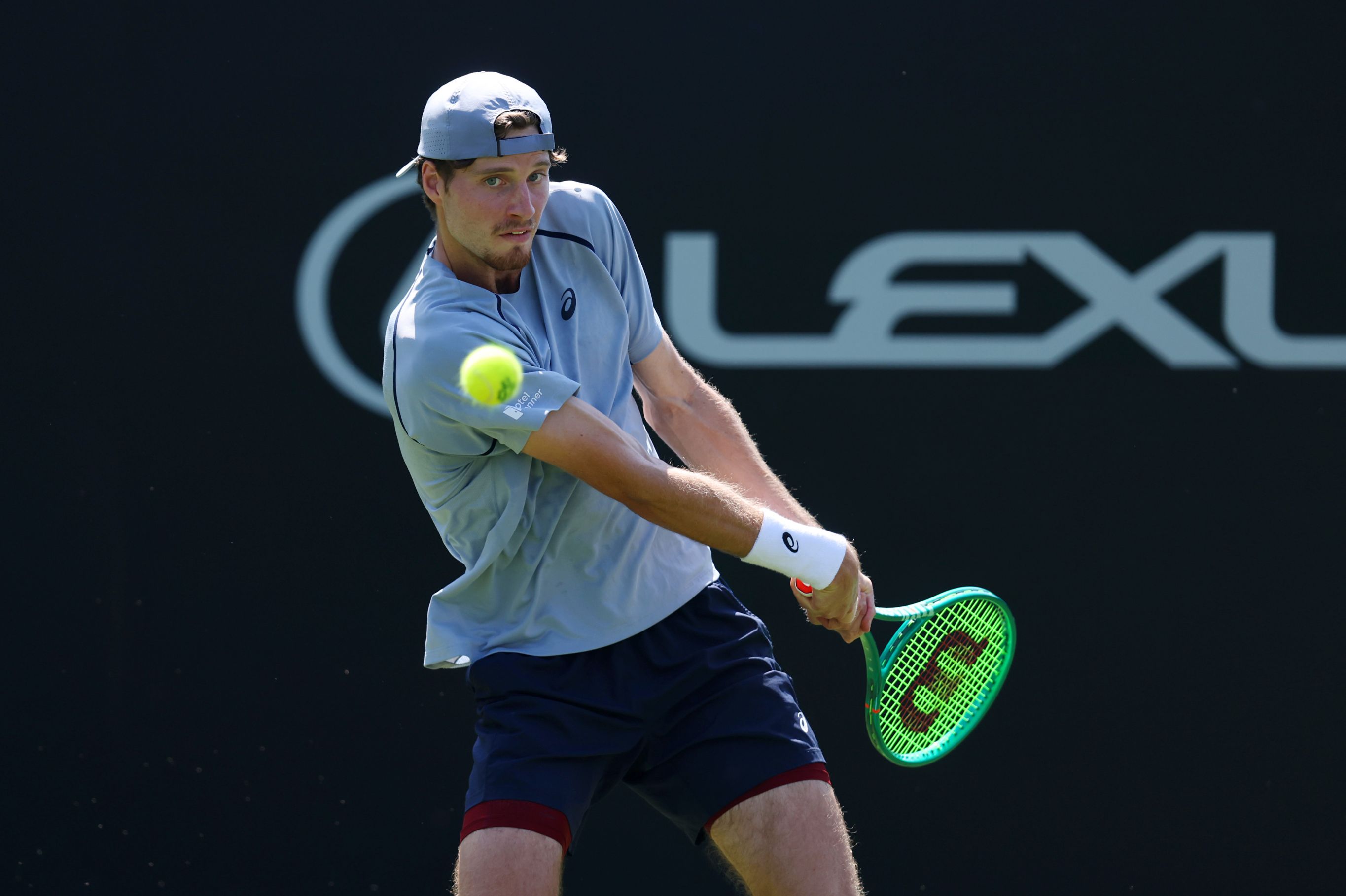 Toby Samuel hitting a backhand on court at the Lexus Eastbourne Open