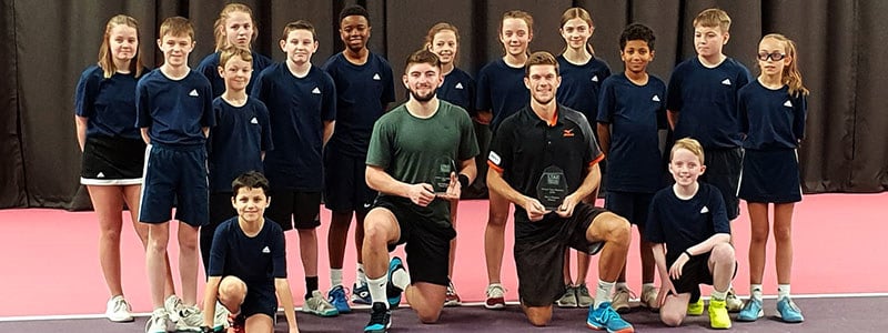 Neil Pauffley and Sean Hodkin with their awards and a group of young boys and girls
